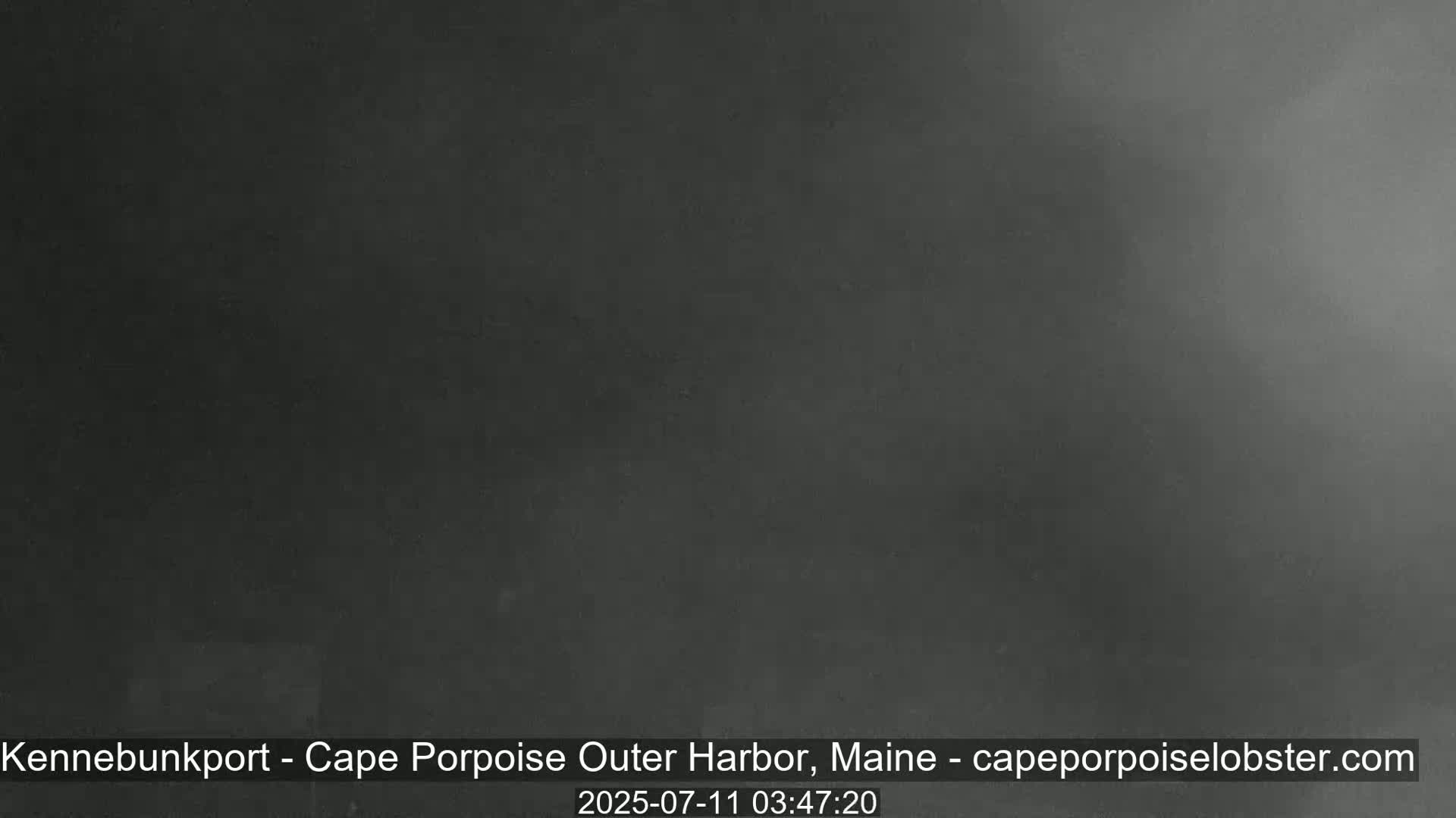 A dark, hazy image shows an overcast sky.