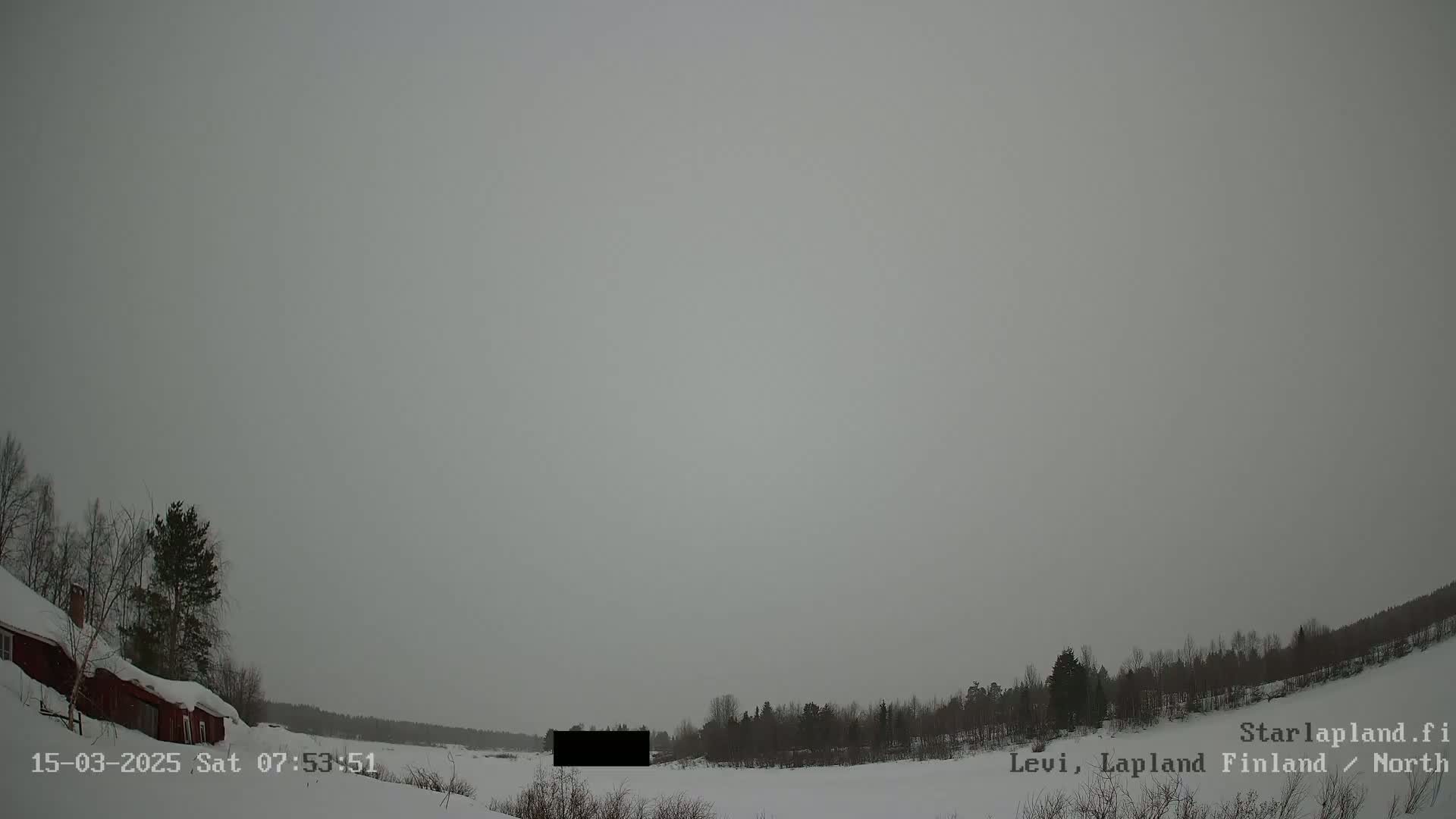 A snow-covered landscape with a red house and a line of trees under an overcast sky.