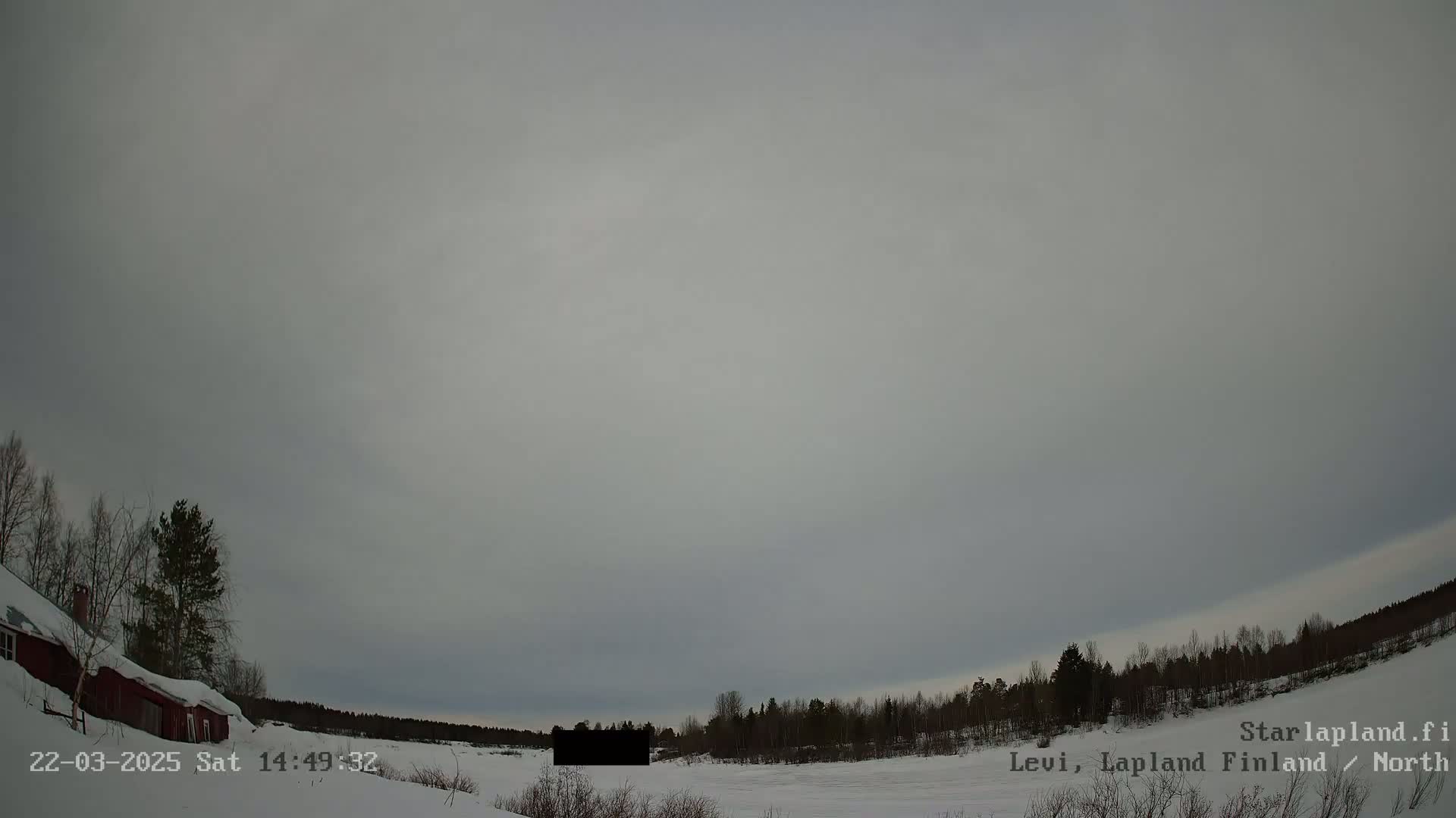 A snow-covered landscape with a red house and a line of trees is visible under an overcast sky.