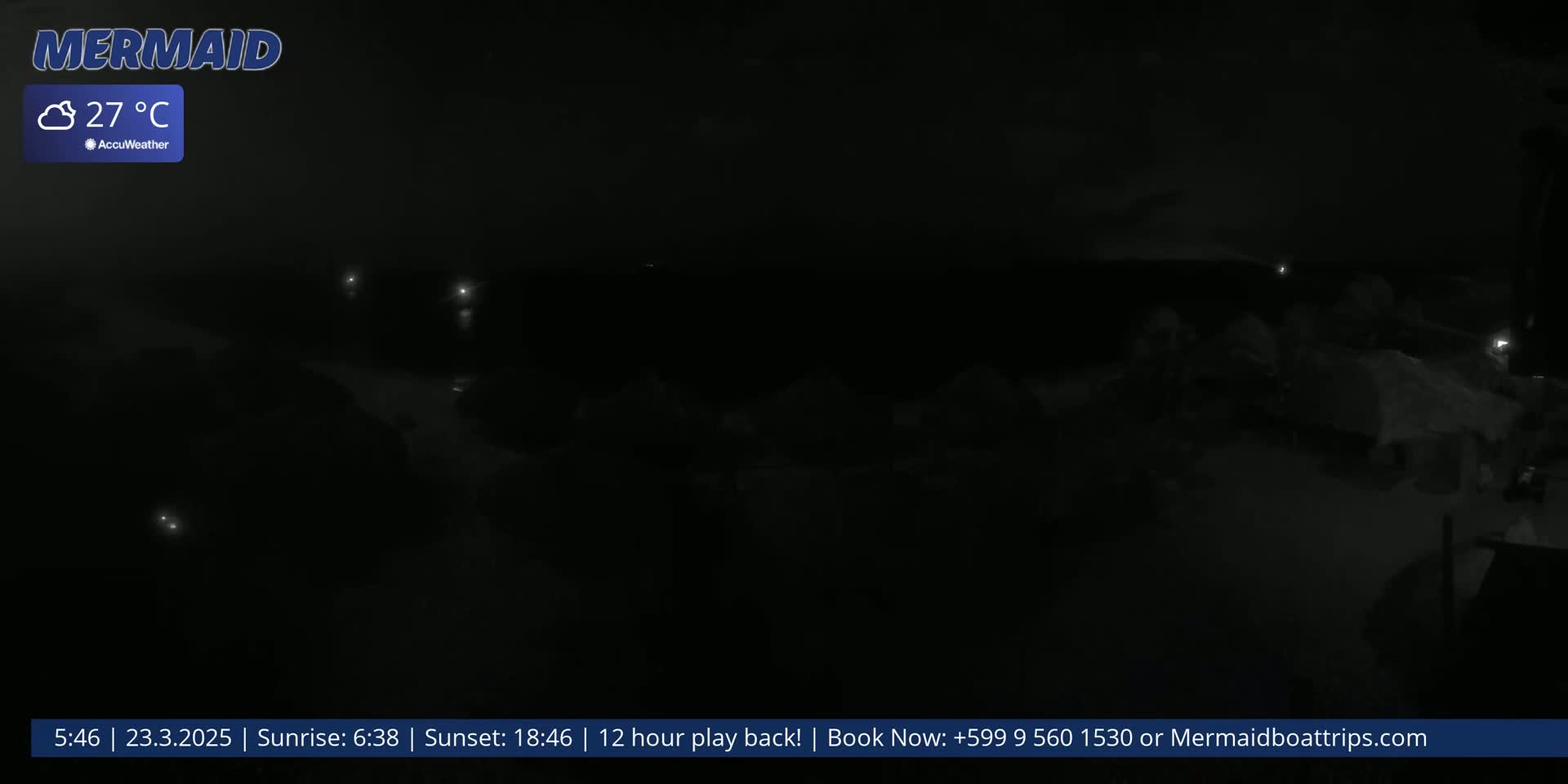 A dark, nighttime scene shows faintly lit objects and what appears to be a group of people or structures in the distance under cloudy skies with a temperature of 27°C.