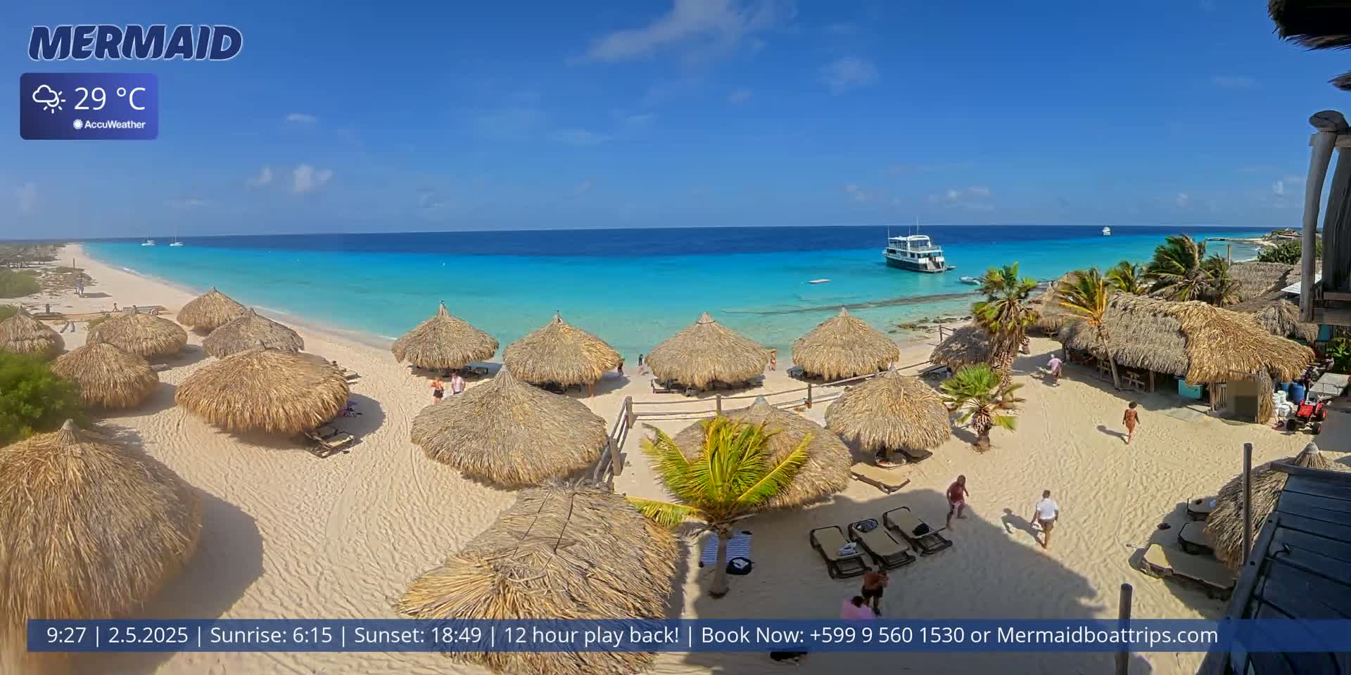 A sunny beach with turquoise water, thatched-roof huts, and a few people is shown, with a boat visible in the distance.