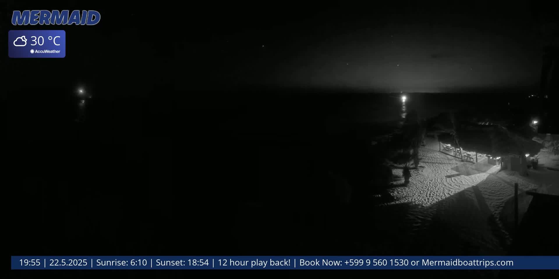 A nighttime, 30°C beach scene shows a dimly lit sandy area with a structure and palm trees near a dark ocean.