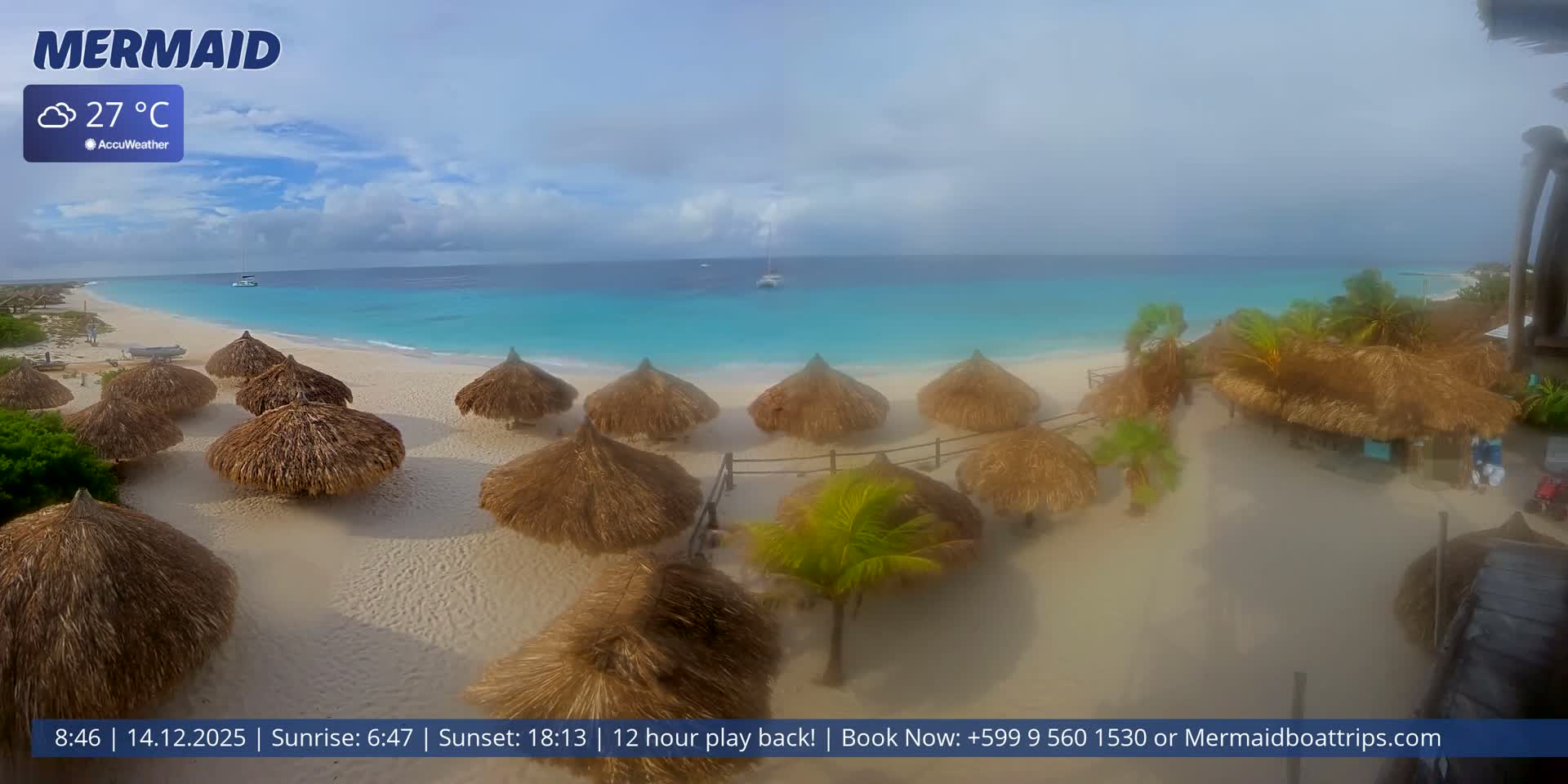 Under a cloudy night sky with a bright, obscured moon, a dimly lit beach features dark thatched umbrellas and a sailboat anchored in the calm ocean, reflecting distant lights.