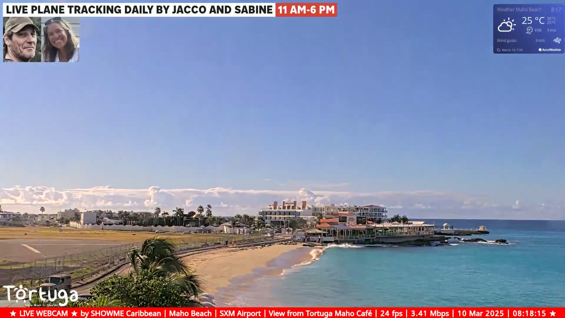 A mostly sunny beach scene with turquoise water shows a coastal town, an airport runway, and a restaurant, under partly cloudy skies.