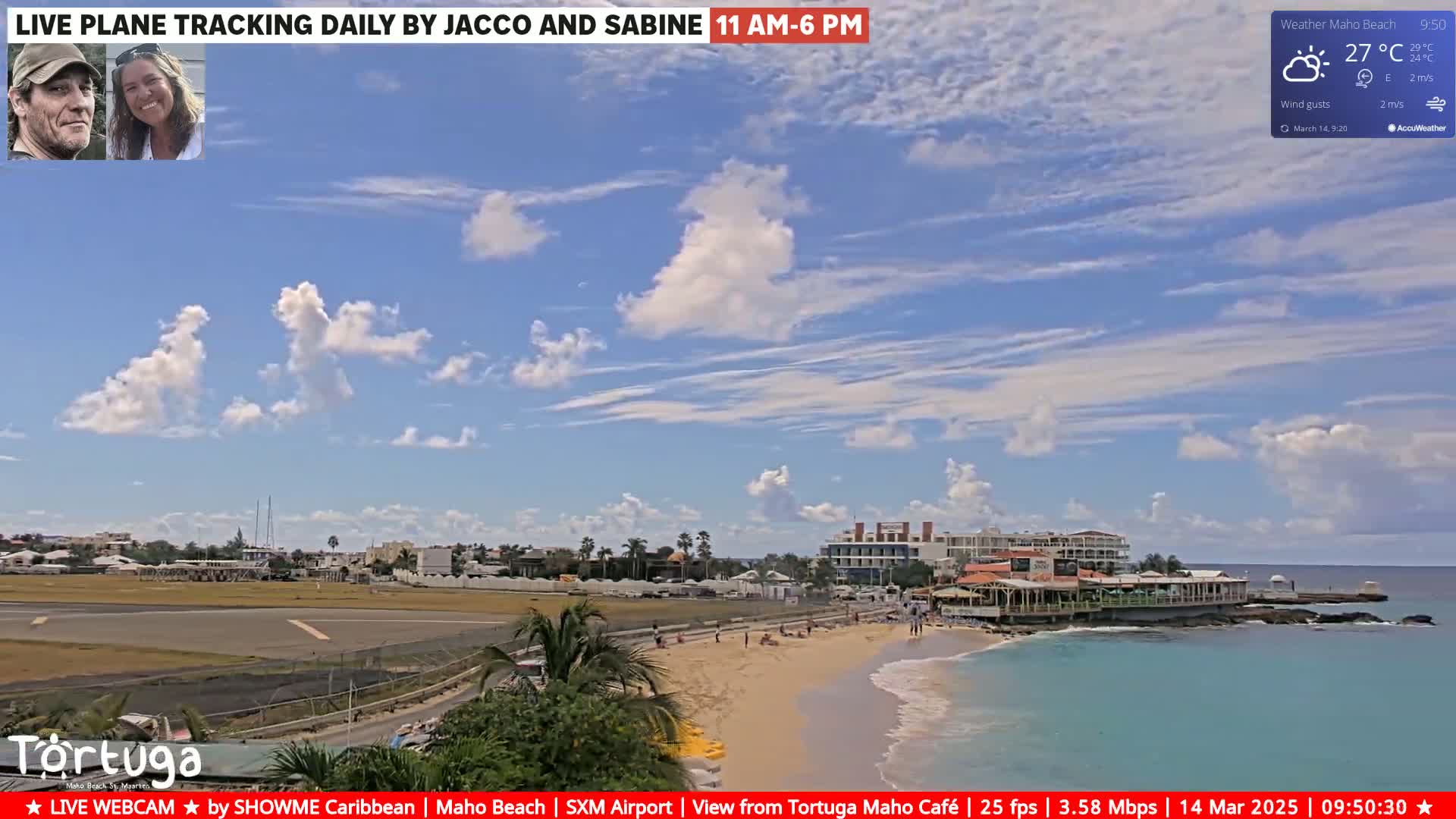 A beach scene on a partly sunny day with scattered cumulus clouds shows a sandy beach, turquoise water, a restaurant, and an airport runway in the background.