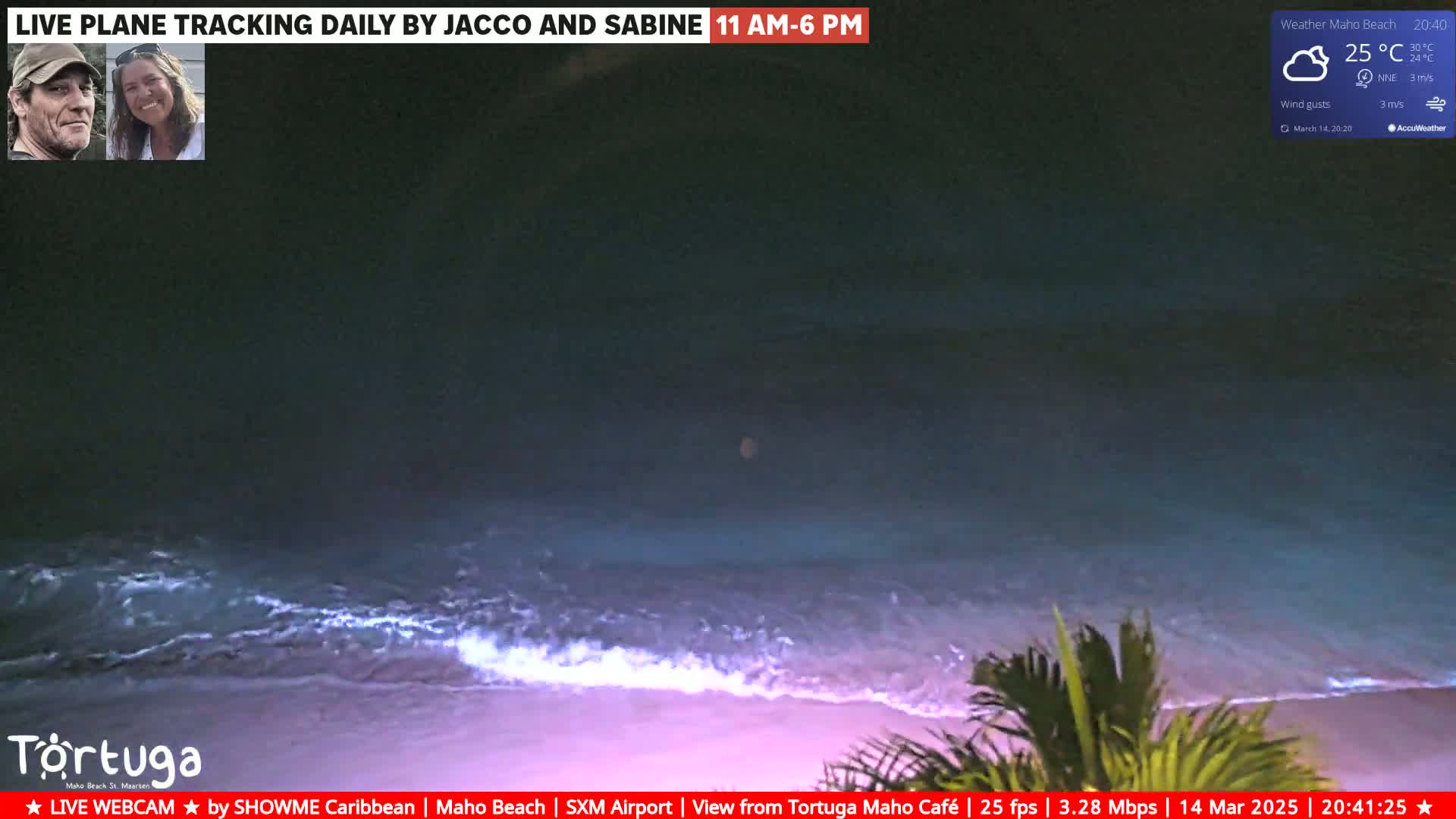 A nighttime beach scene shows gentle waves lapping the shore under a cloudy sky.
