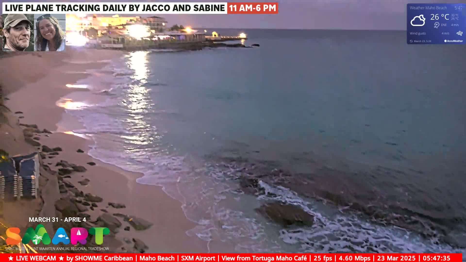 A sandy beach with gentle waves laps at the shore under a twilight sky.