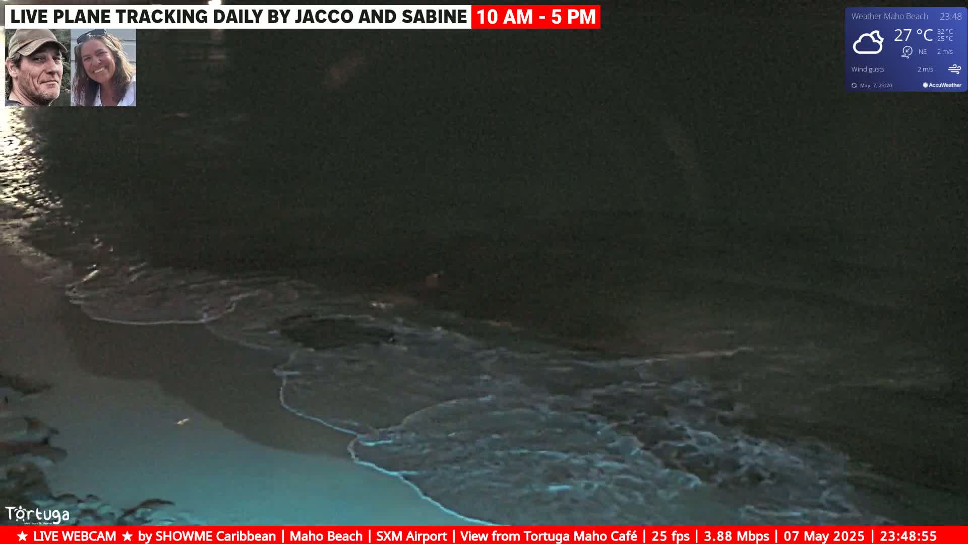 Dark waves lap a sandy shore at night under partly cloudy skies.