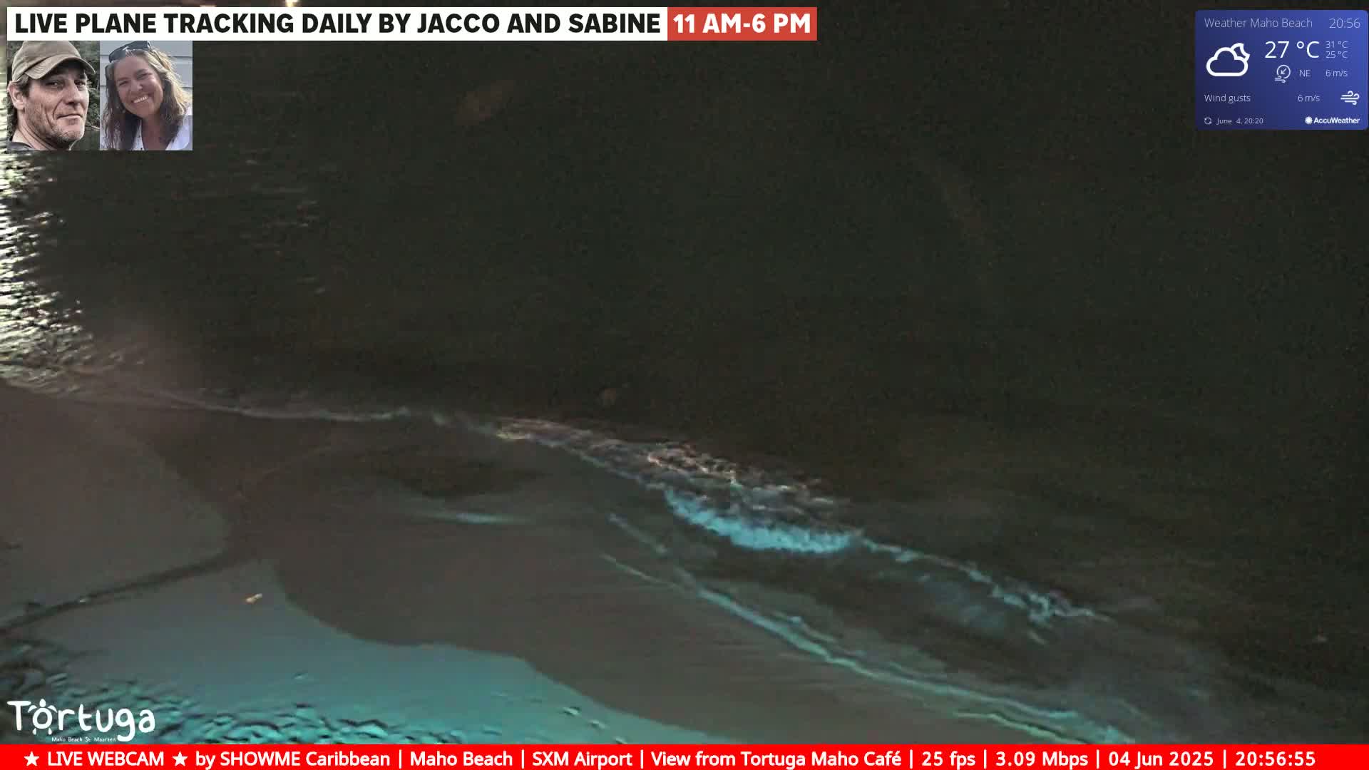 Dark, nighttime ocean waves glow faintly bioluminescent under a partly cloudy sky.