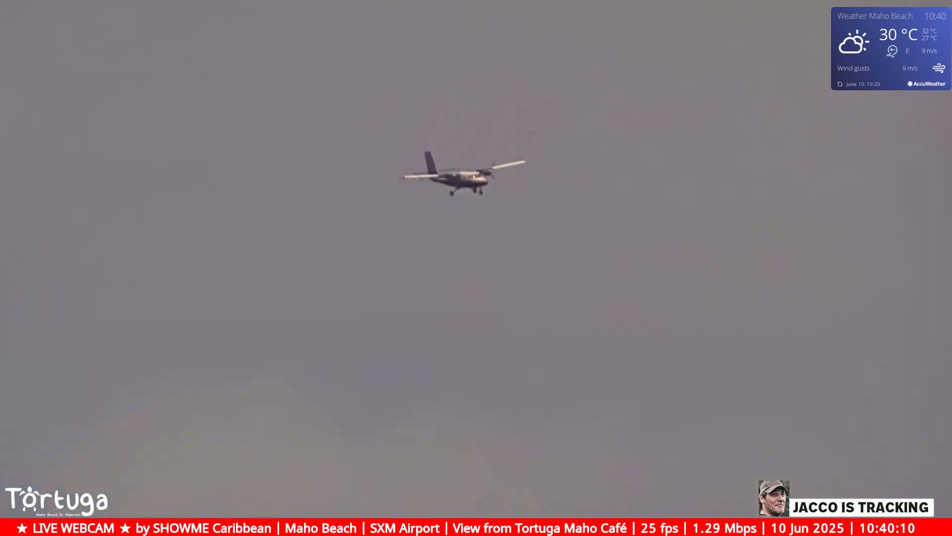 A small airplane flies in a hazy, overcast sky.