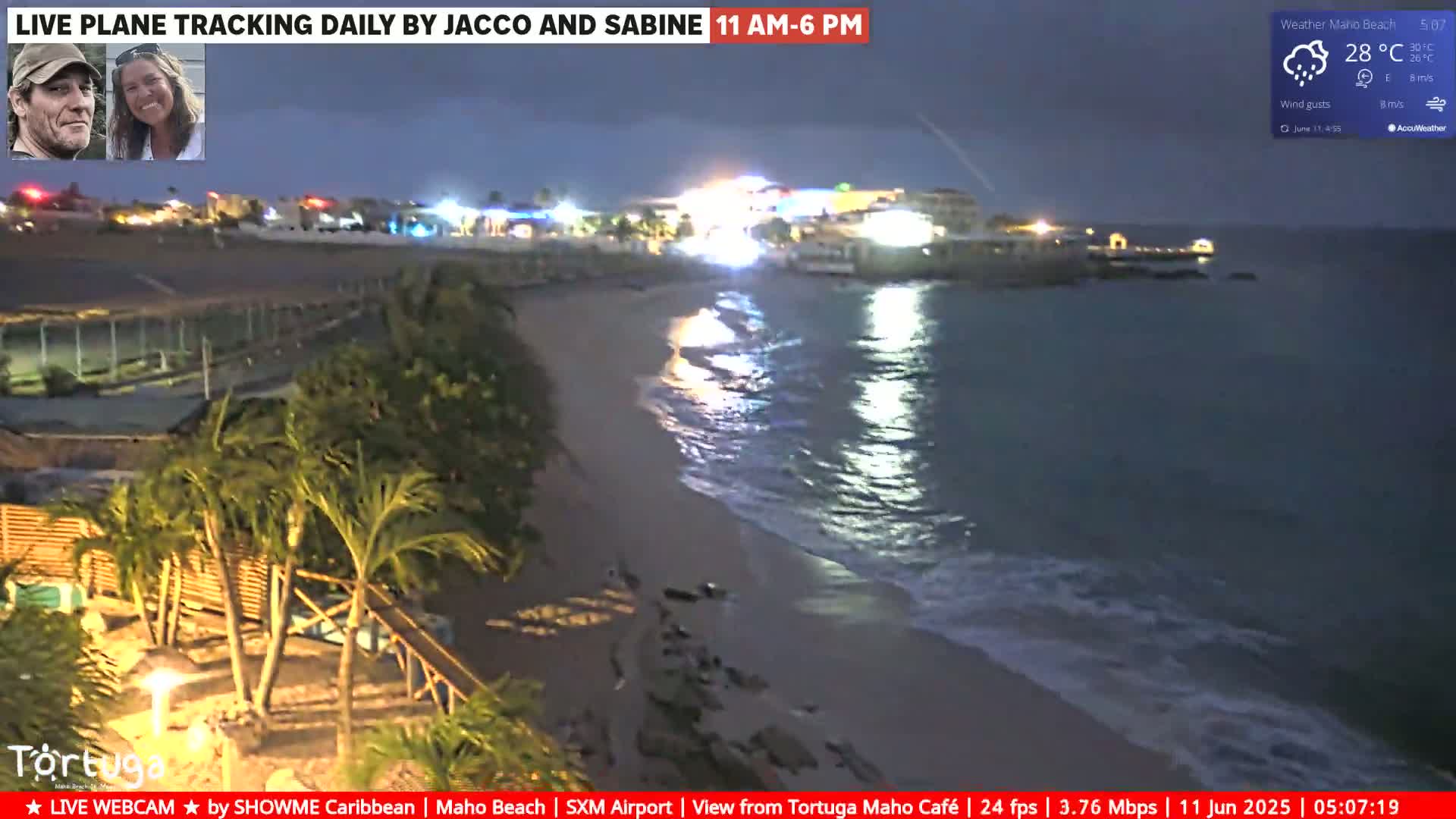 A nighttime beach scene shows a sandy shore with gentle waves lapping under a partly cloudy sky.