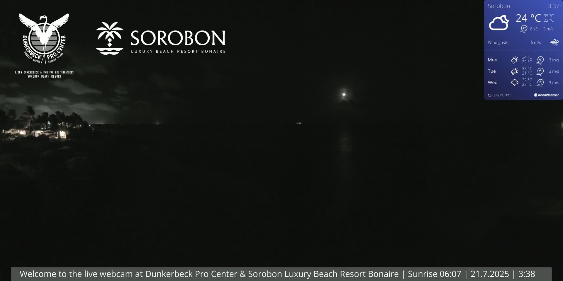 A nighttime coastal scene under a partly cloudy sky, with a bright moon visible and some lights in the distance.