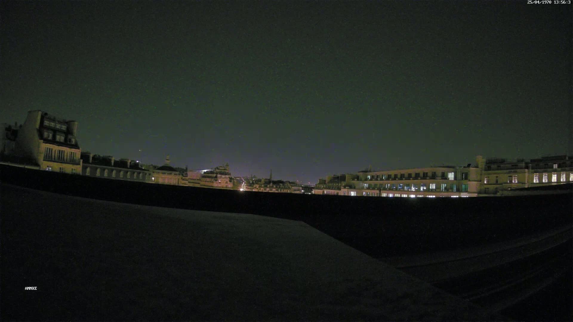 A nighttime view of city buildings and a dark sky.