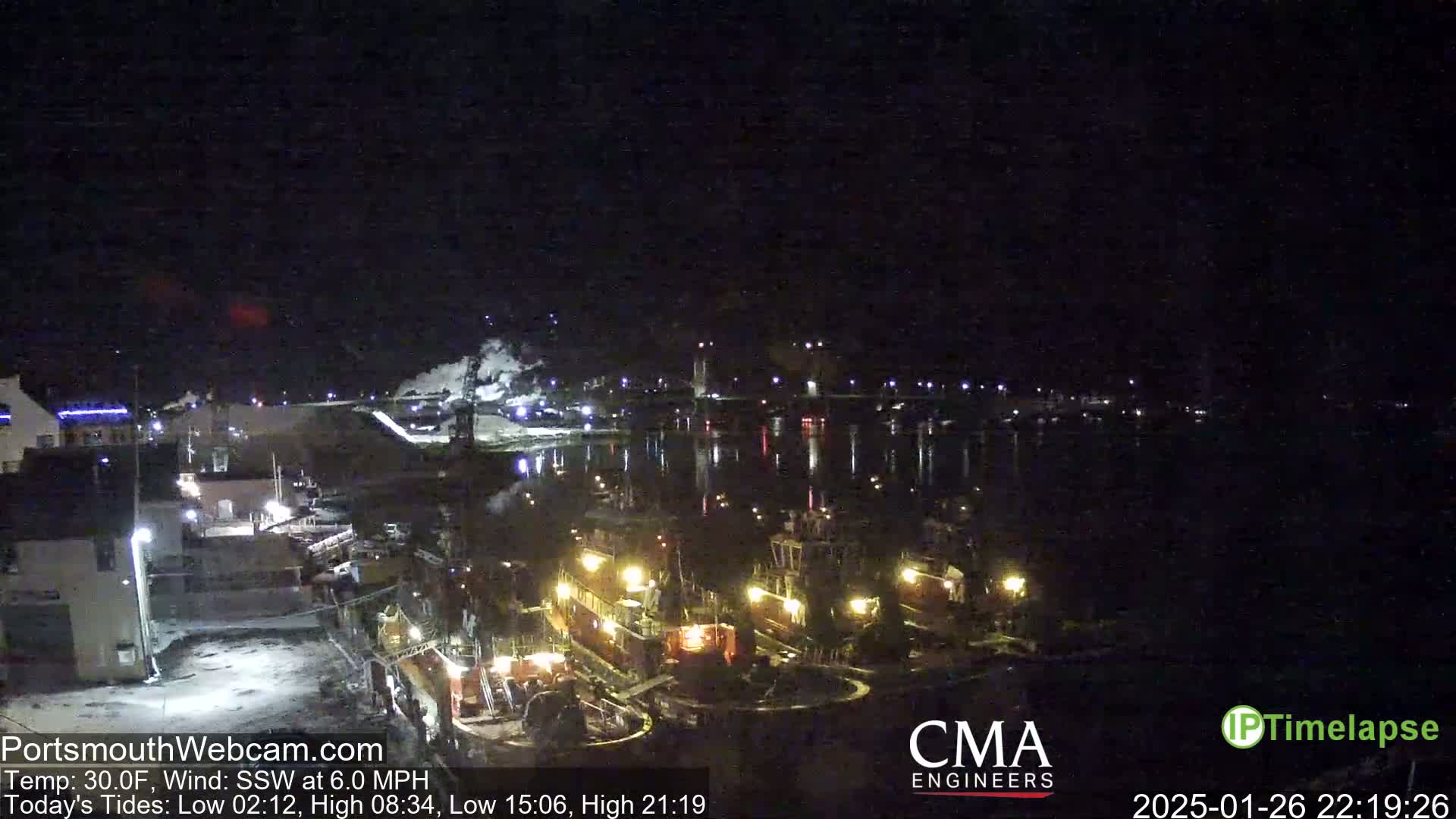 At night, several tugboats are docked at a waterfront, under a dark sky with a temperature of 30°F and a south-southwesterly wind.