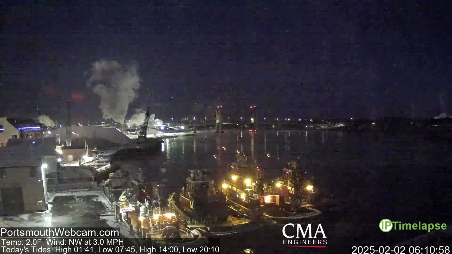 A nighttime scene shows several tugboats in a harbor, with smoke rising from industrial areas in the background under a dark sky.