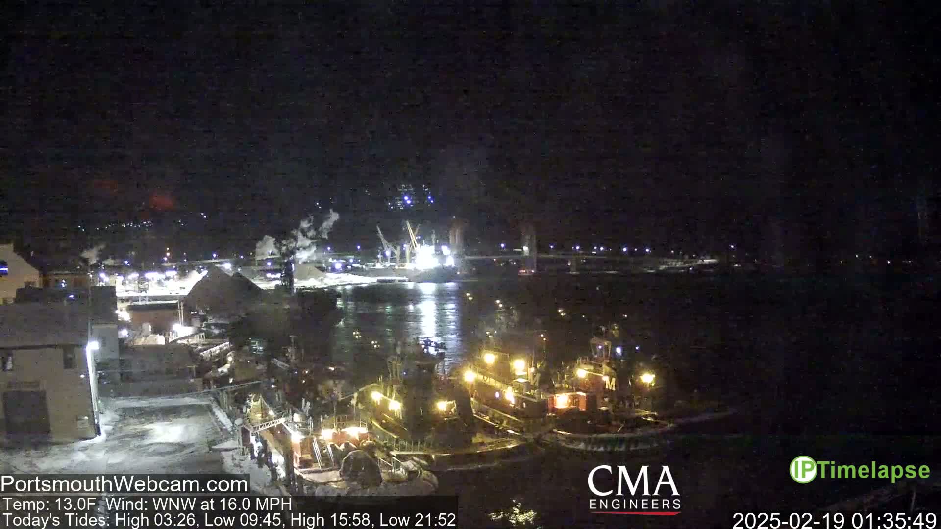 Several tugboats are moored in a harbor at night under a dark sky with a WNW wind of 16 mph and a temperature of 13°F.
