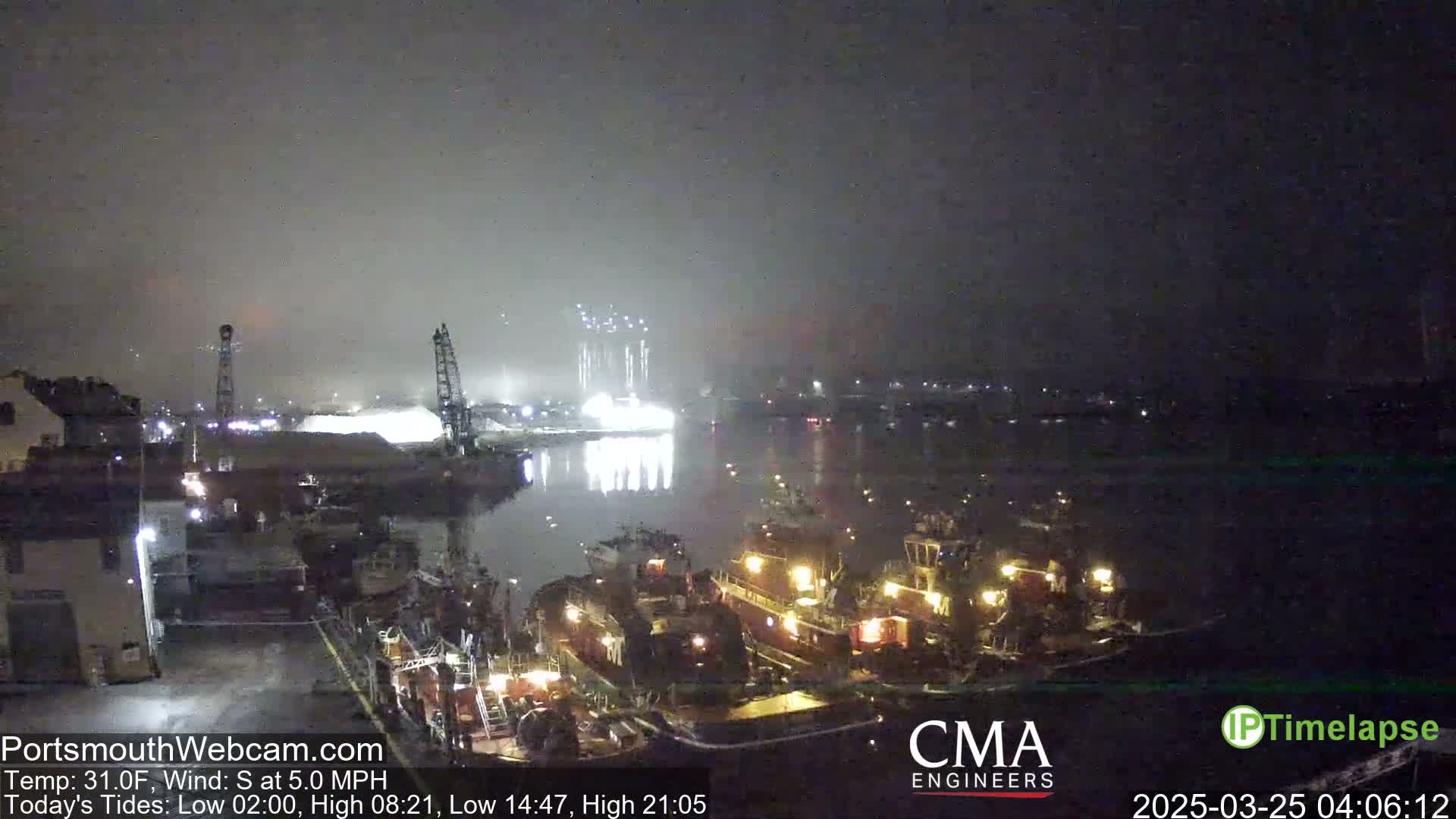 A nighttime harbor scene shrouded in fog shows several tugboats near a dock, with brightly lit industrial structures across the water.