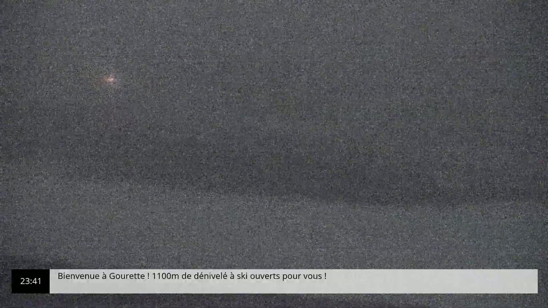 A grainy, dark image shows a mostly obscured scene at night.