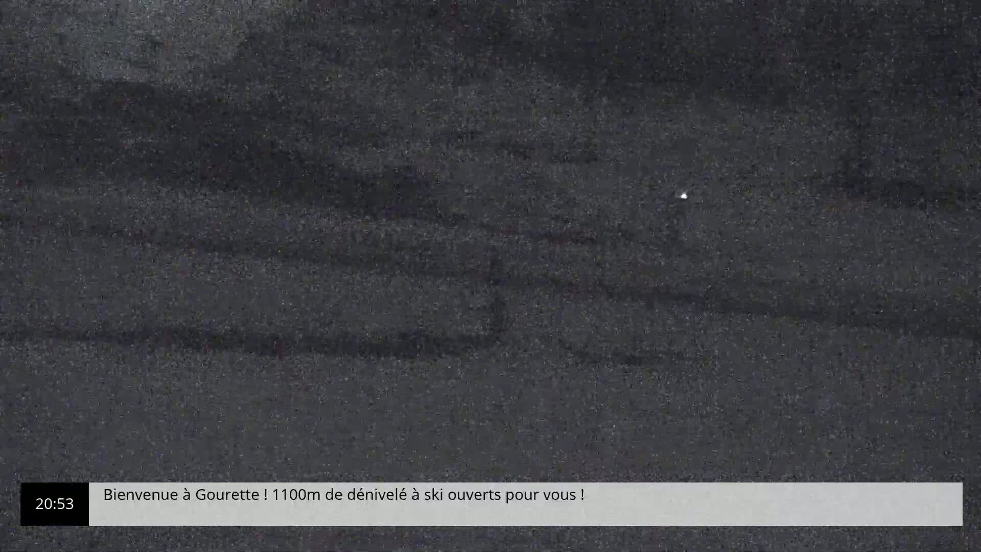 A grainy, dark image shows a mostly featureless, dark gray surface.