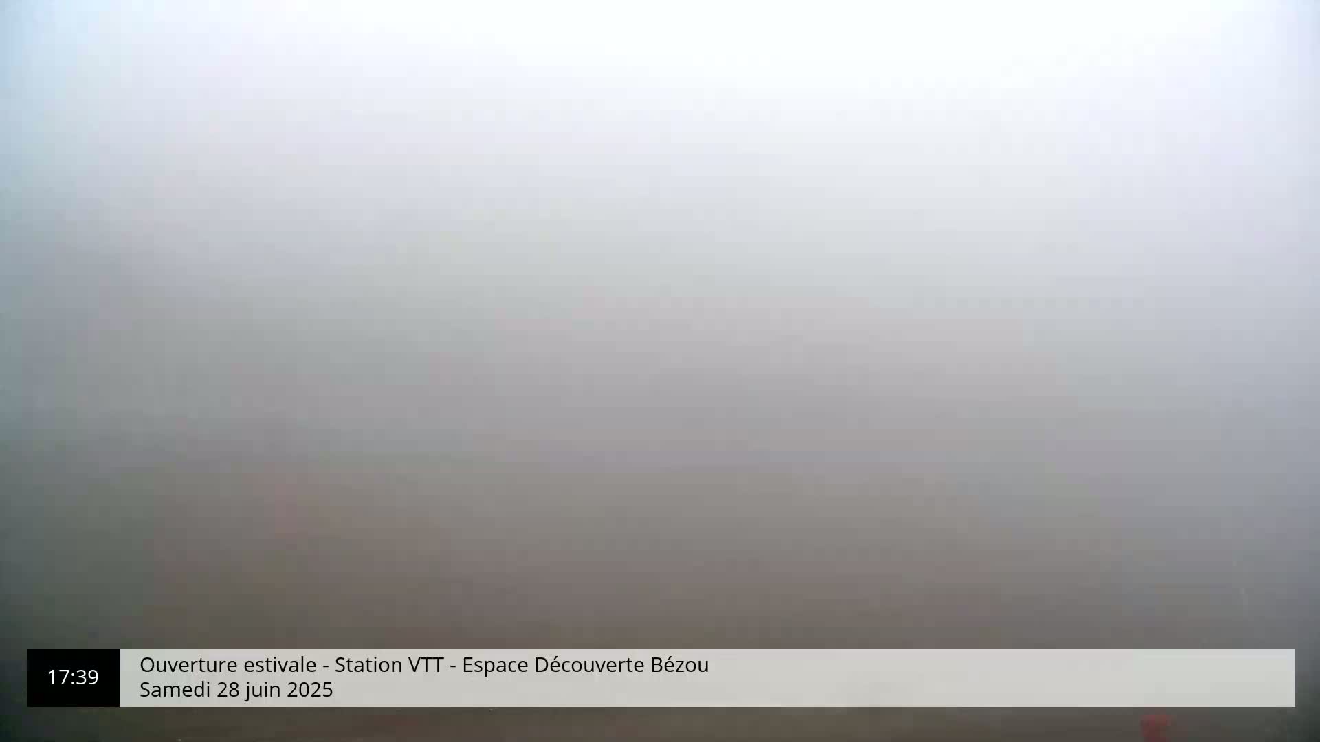 A thick fog obscures the view of an outdoor scene.