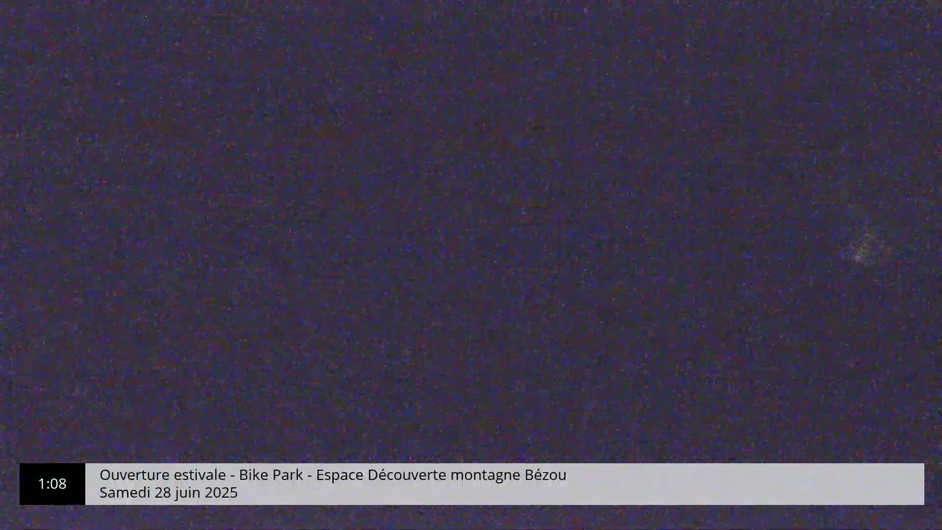 A dark, grainy image showing a mostly uniform dark purple-blue color.