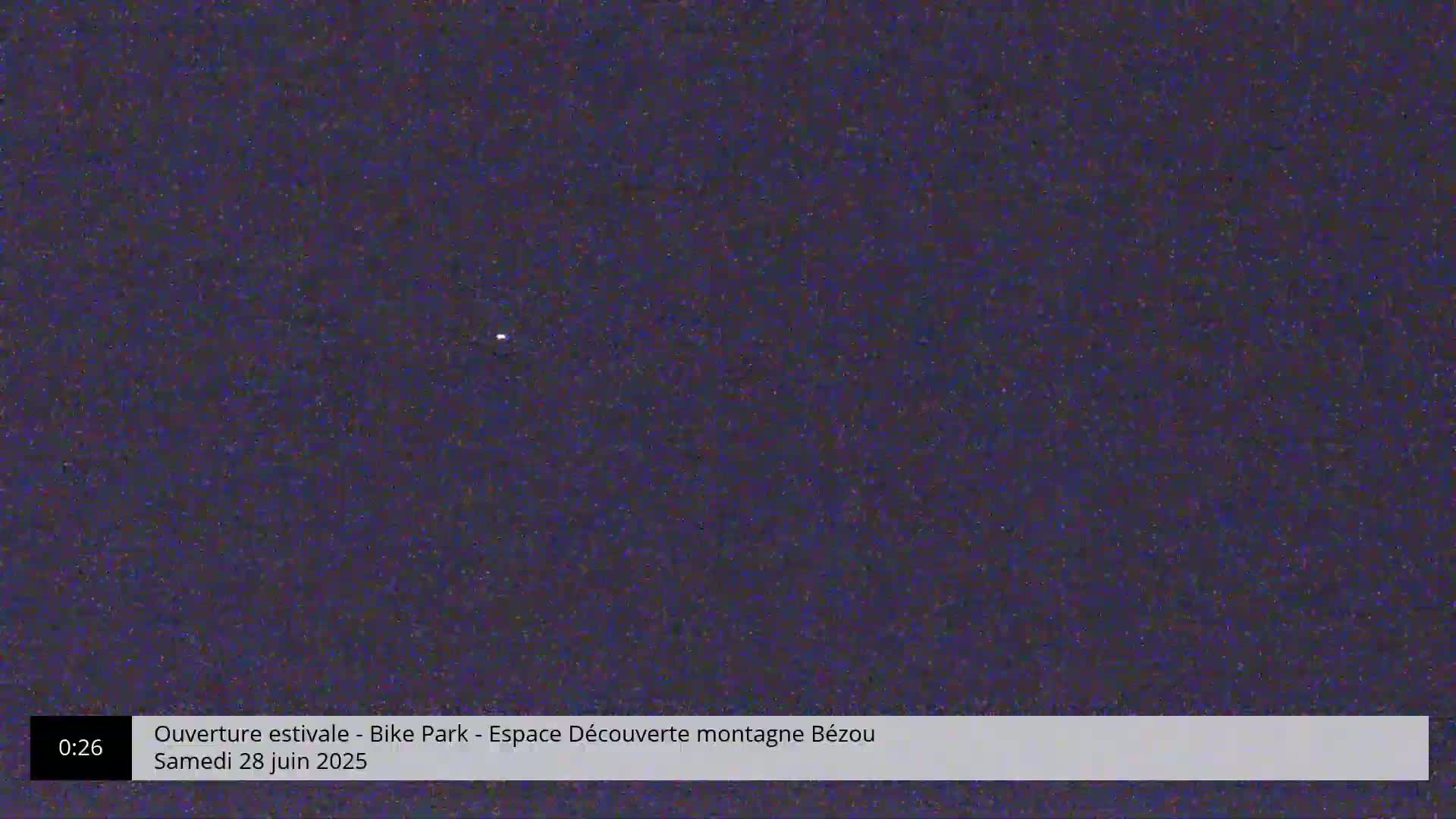 A dark, night-time scene shows a single, faint light in the distance.