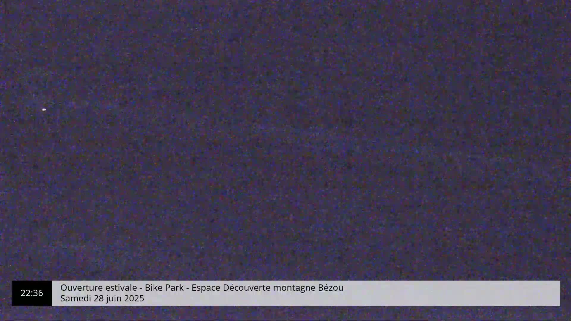 A dark, grainy image shows a mostly featureless, dark purple-blue night scene.