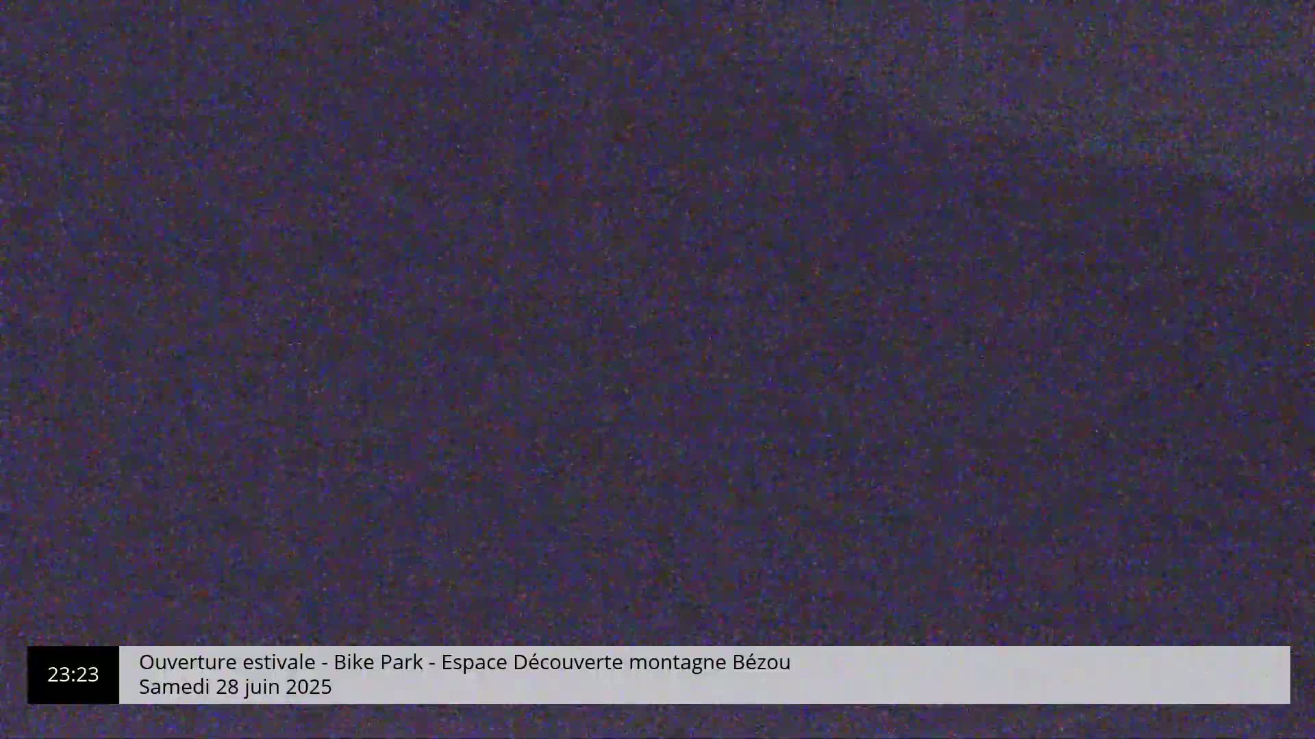 A dark purple, grainy image fills the frame.
