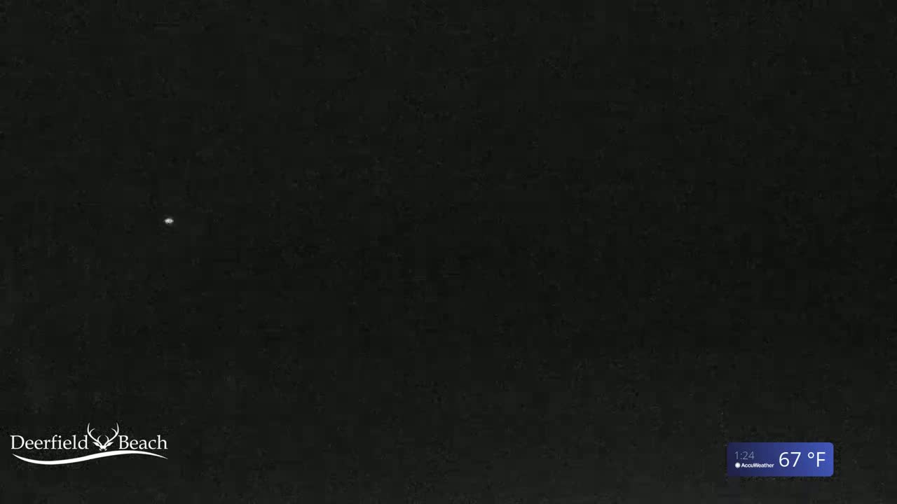 A single, bright point of light is visible against a completely dark night sky.