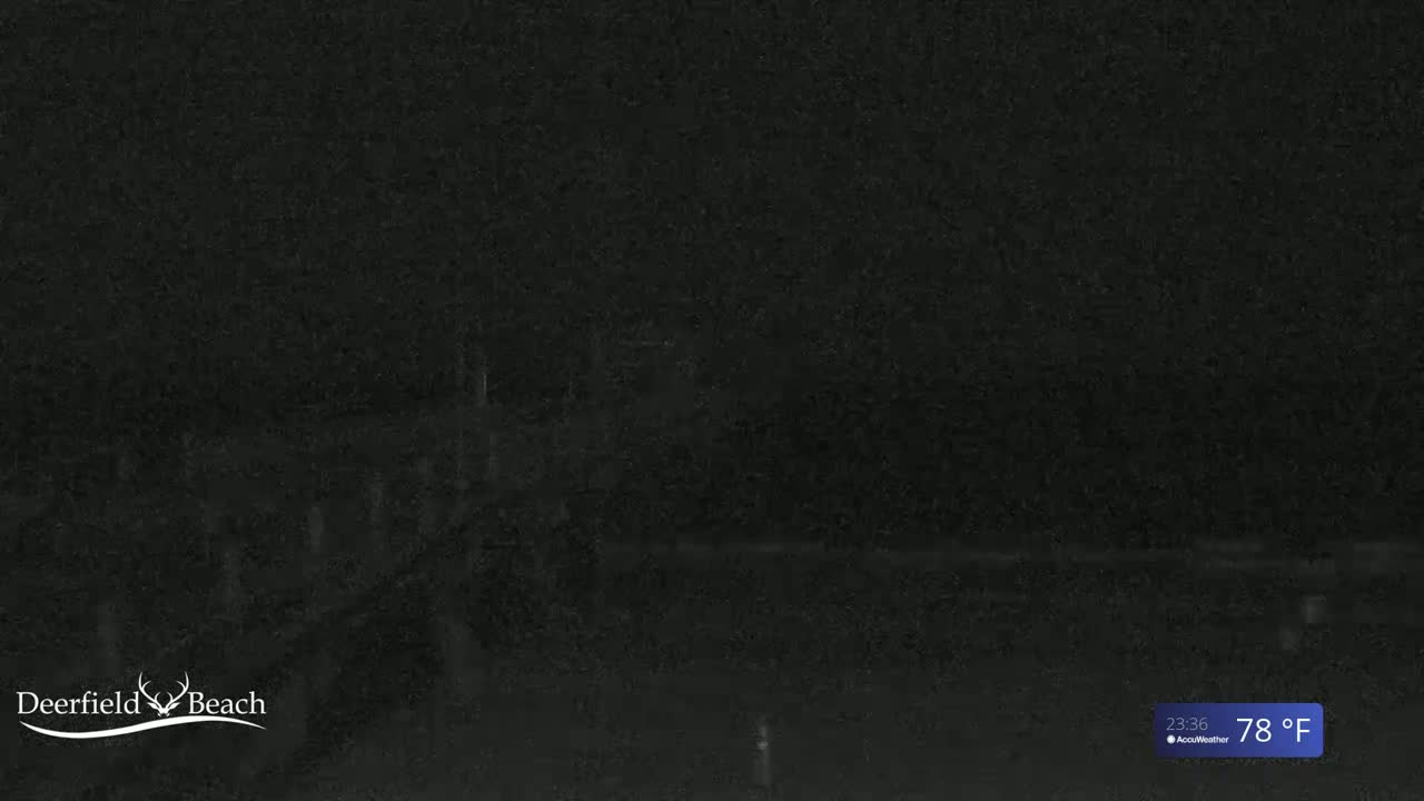 A very dark, nighttime scene shows a mostly indistinct view of a beach under a dark sky with a temperature of 78 degrees Fahrenheit.