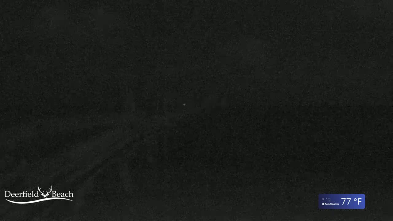 A mostly dark image shows a dark, grainy surface with a temperature of 77°F.