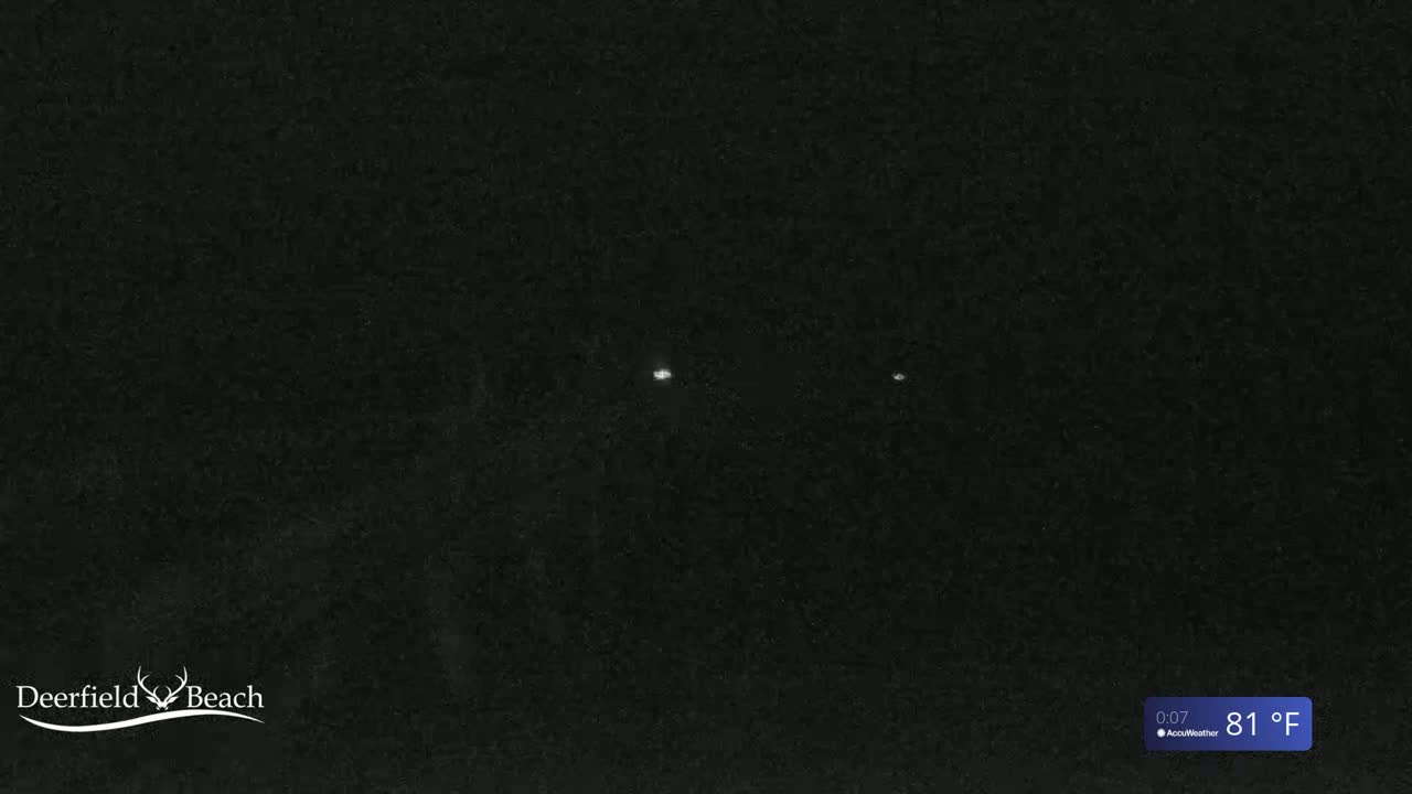 A dark, nighttime scene shows three faint lights in the distance under a clear sky, with a temperature of 81°F.