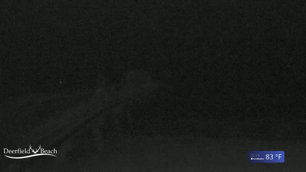 A dark, nighttime image shows a mostly obscured view of a beach under an 83°F night sky.