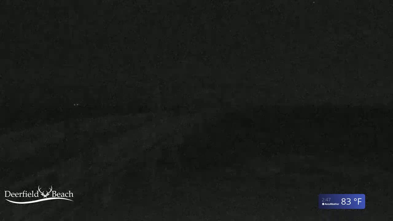 A dark, nighttime scene shows a mostly obscured view of an outdoor area at 83°F.