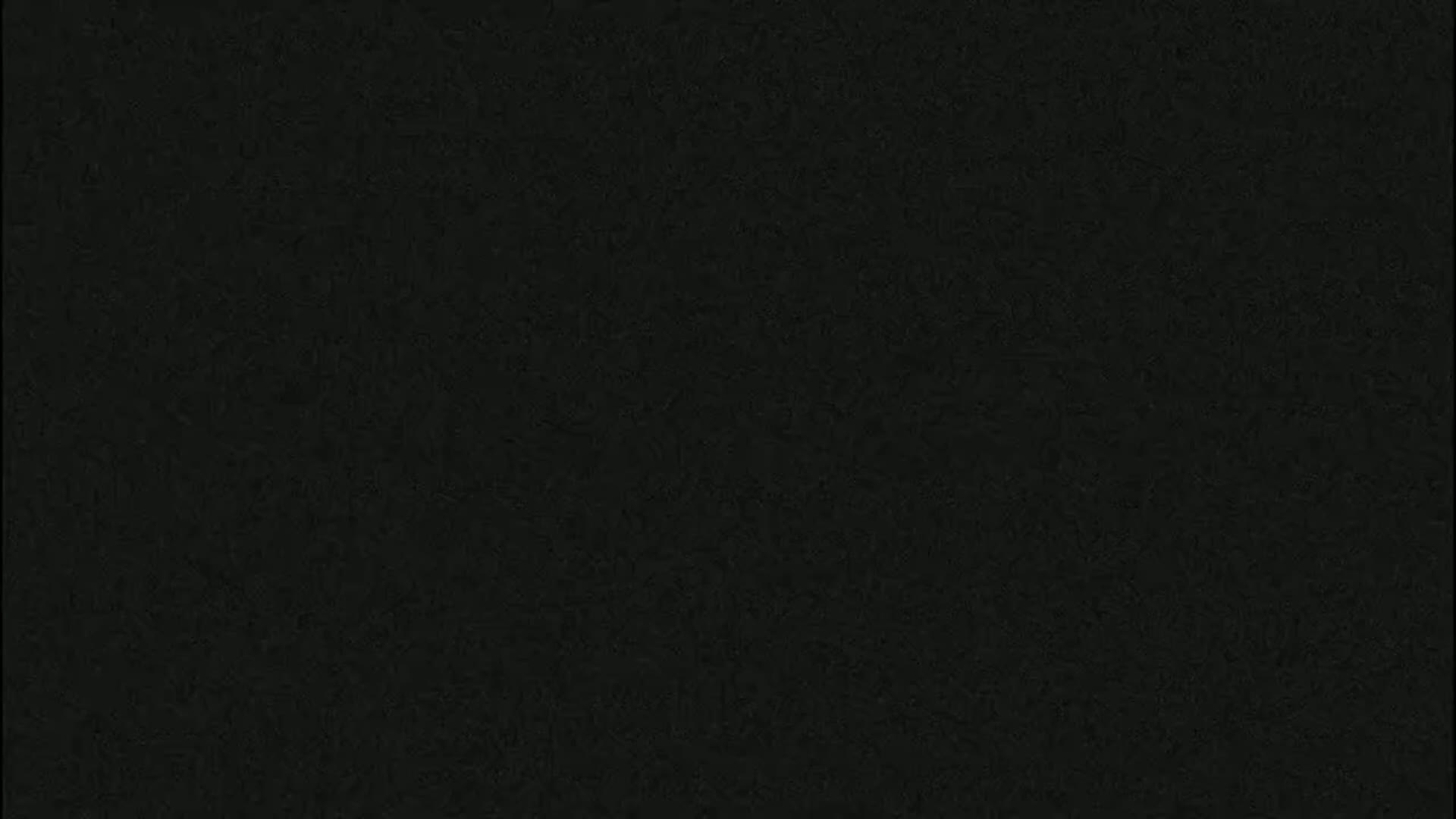 The image shows a dark gray or black textured surface.