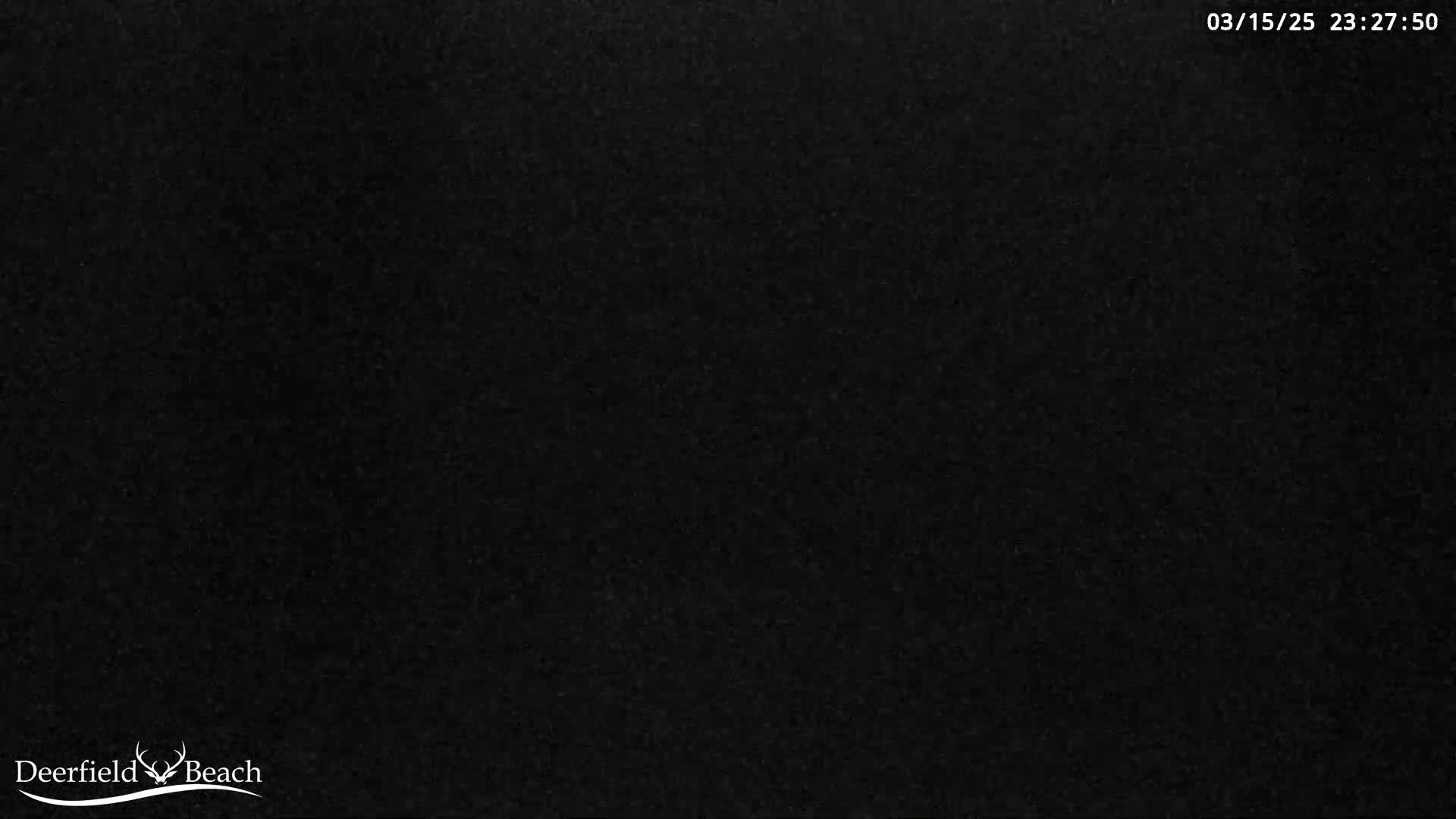 The image is a completely dark, grainy black screen.