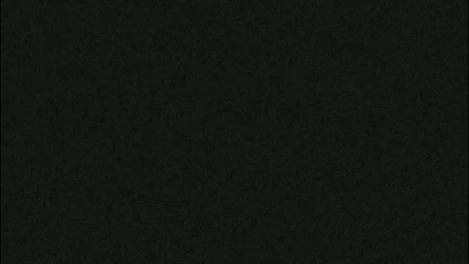 The image shows a dark gray or black textured surface.