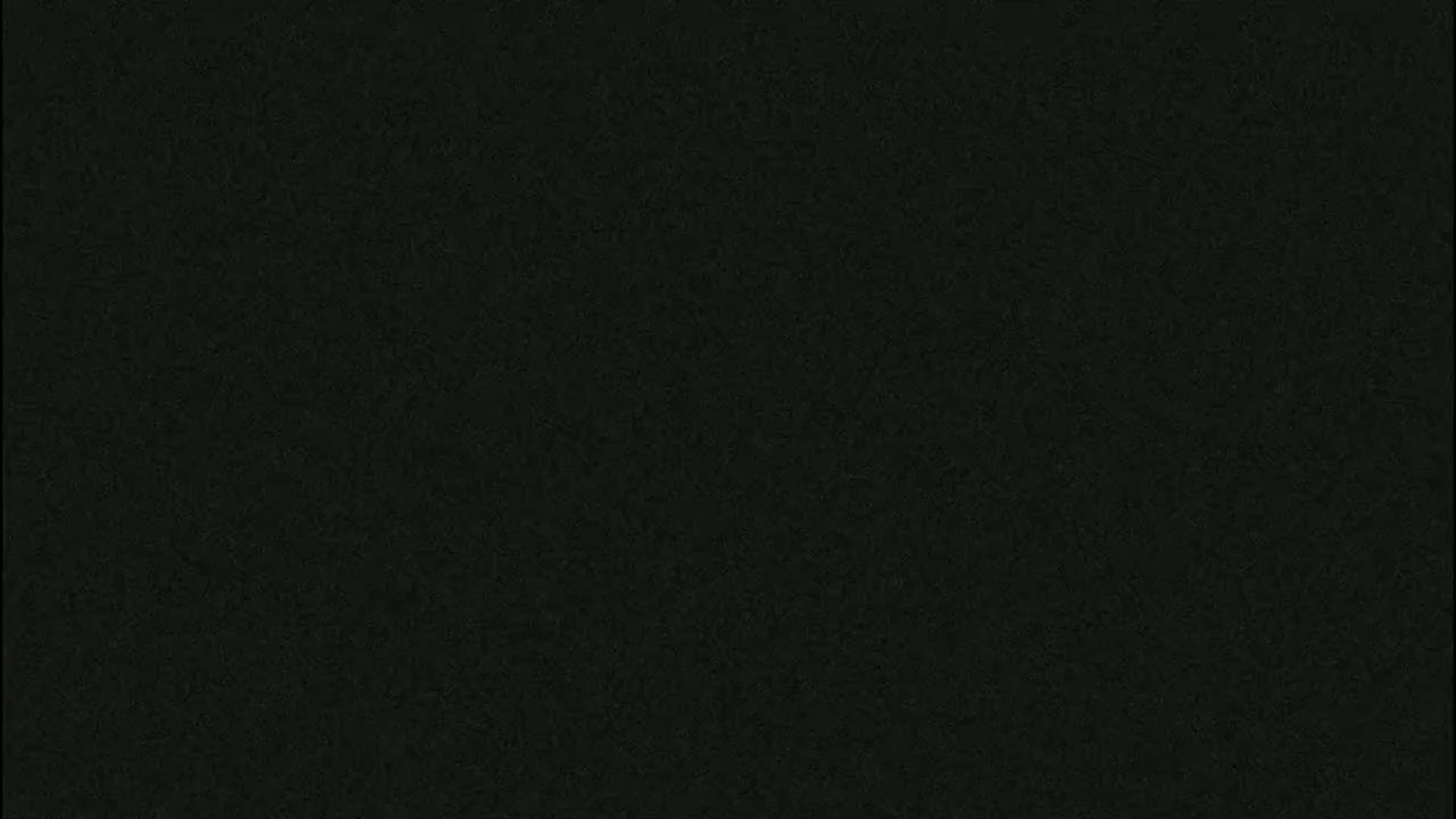 The image shows a dark gray or black textured surface.