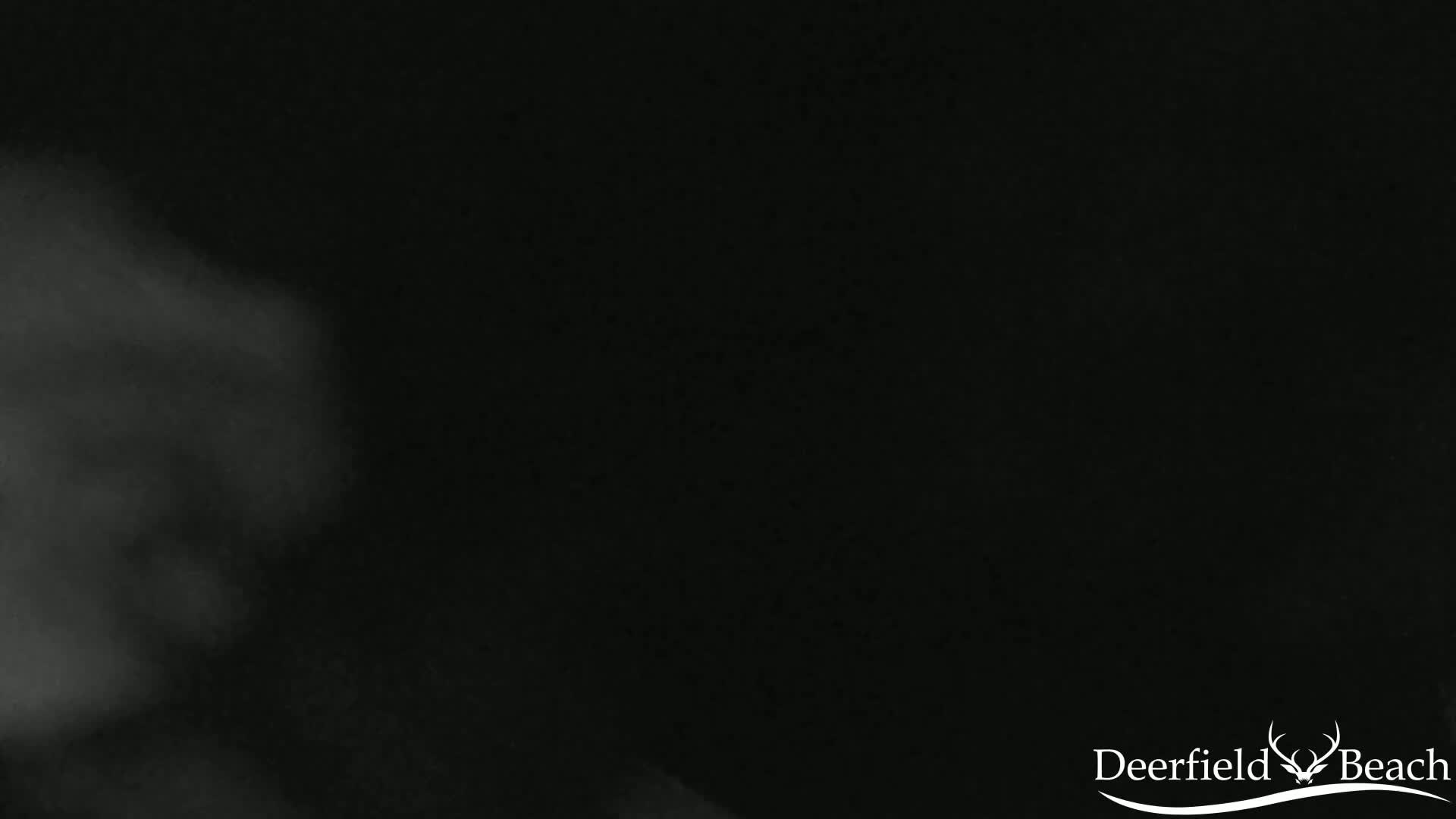 A blurry, dark image shows mostly black with a lighter gray area in the upper left corner that resembles fog or smoke.