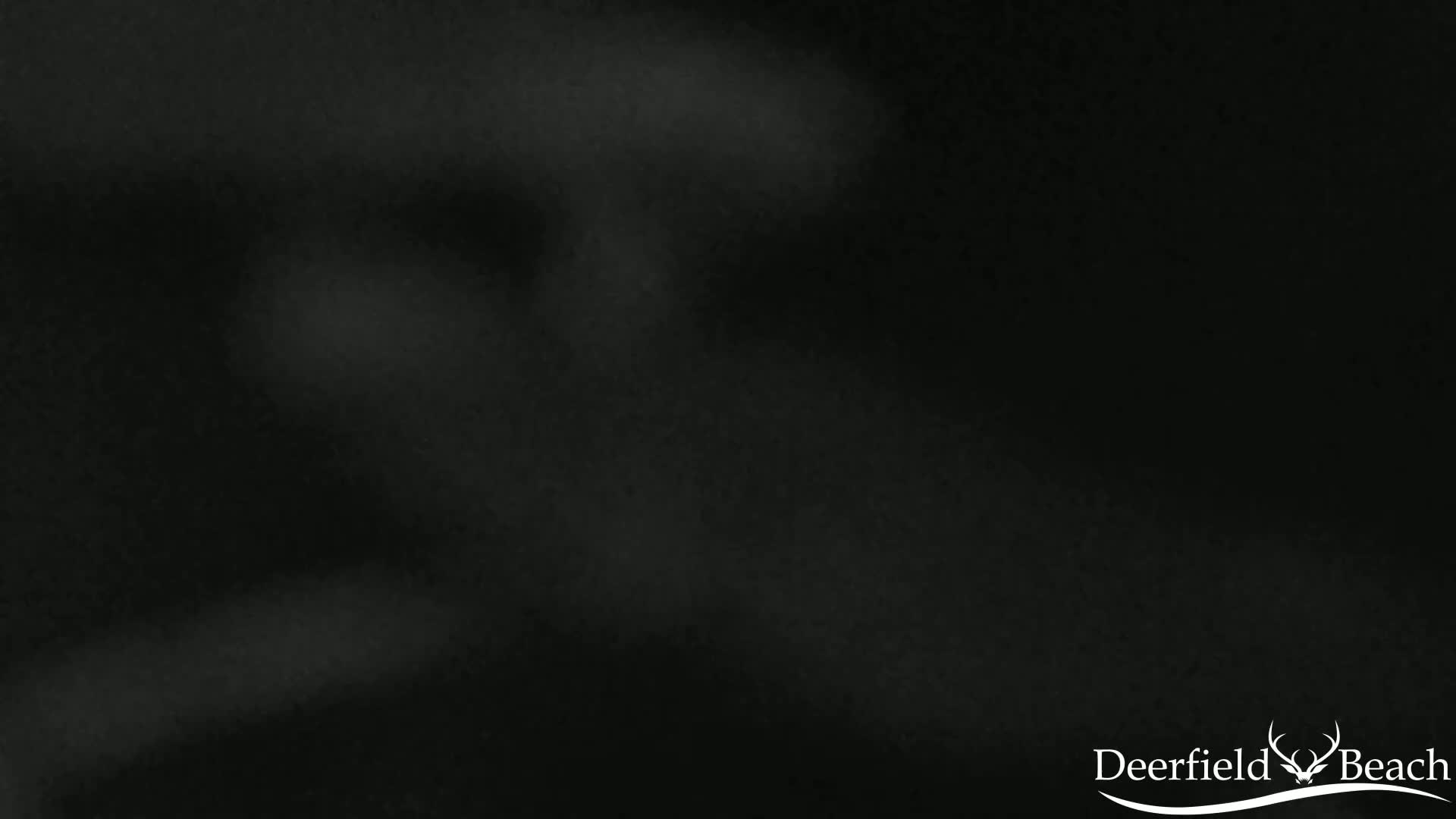 A dark, blurry image shows indistinct shapes and shading in various shades of gray and black.