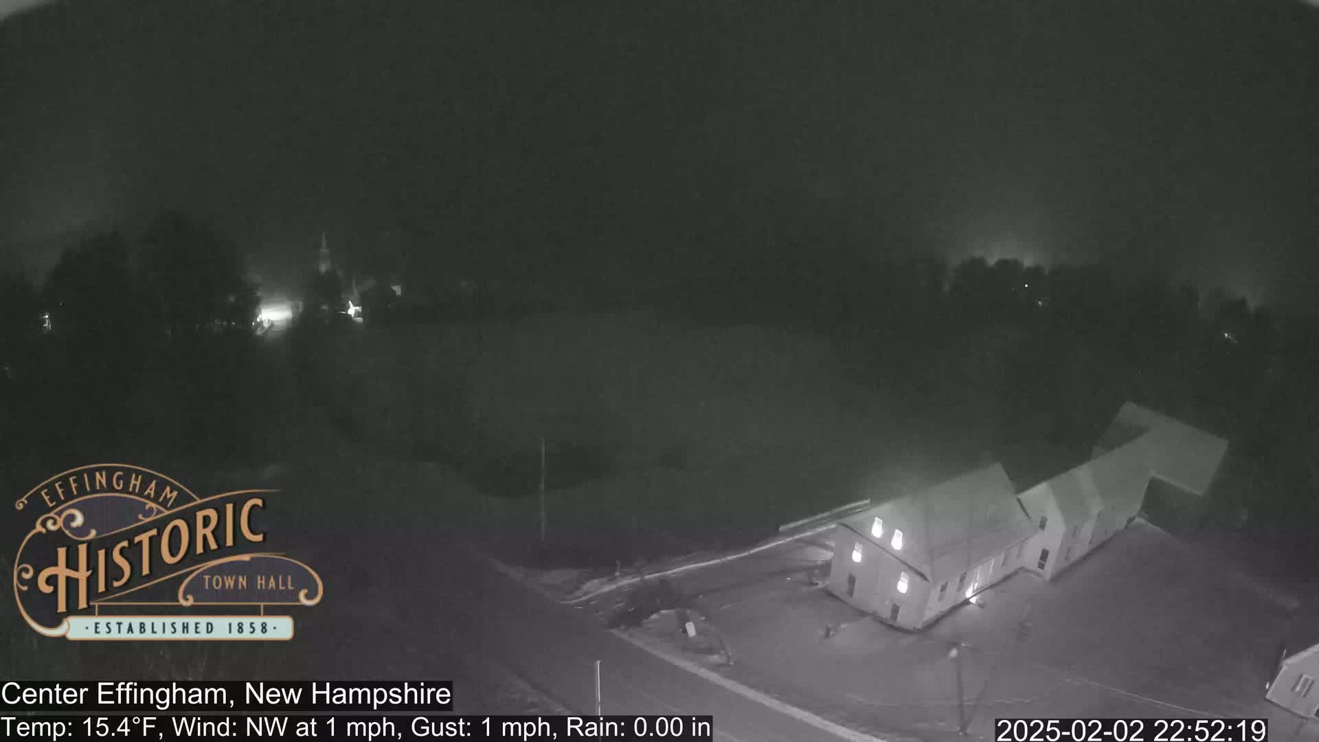 A nighttime, low-light overhead view shows a building and surrounding area with a northwest wind of 1 mph and no rain.