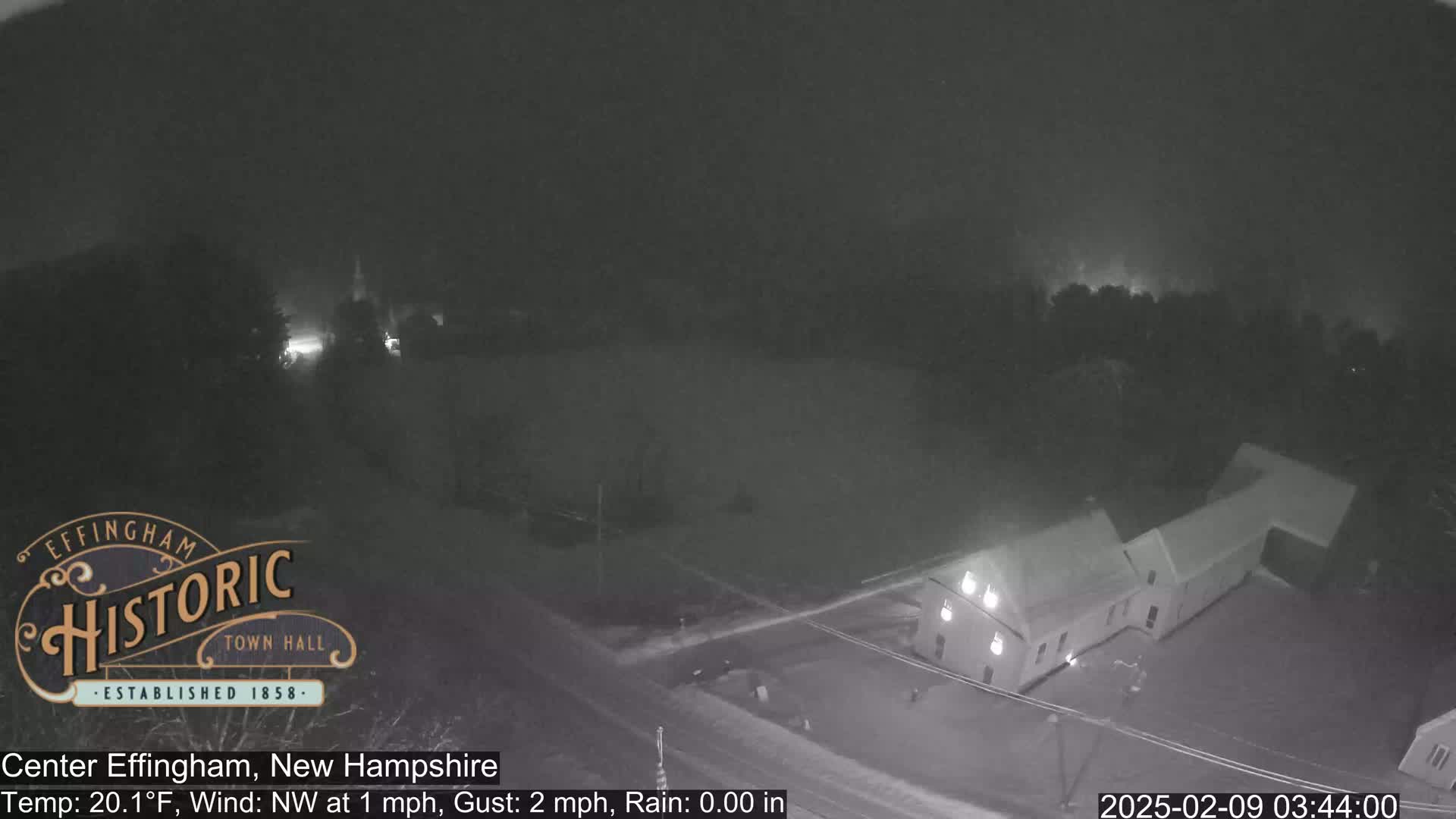 A nighttime, low-light view of a building and surrounding area, with a temperature of 20.1°F and a northwest wind of 1 mph with gusts up to 2 mph.