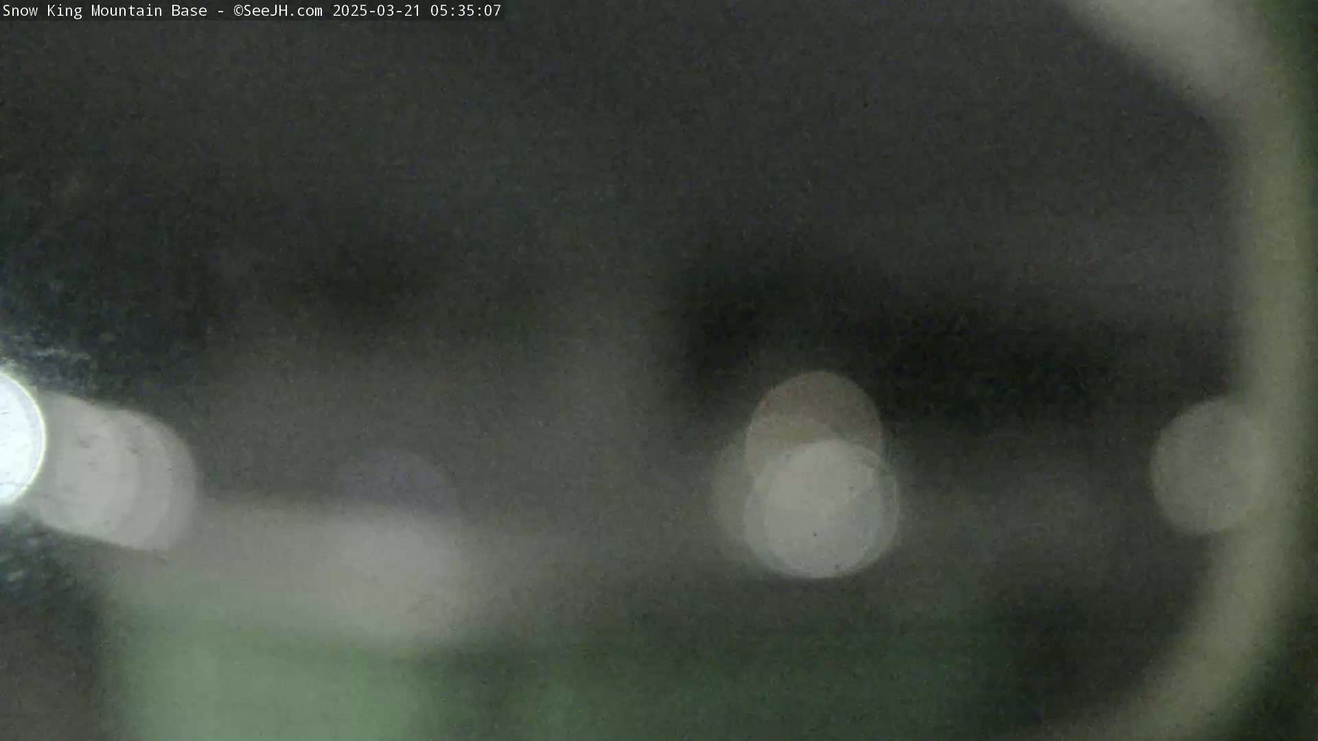 A blurry, dark image shows out-of-focus lights at night.