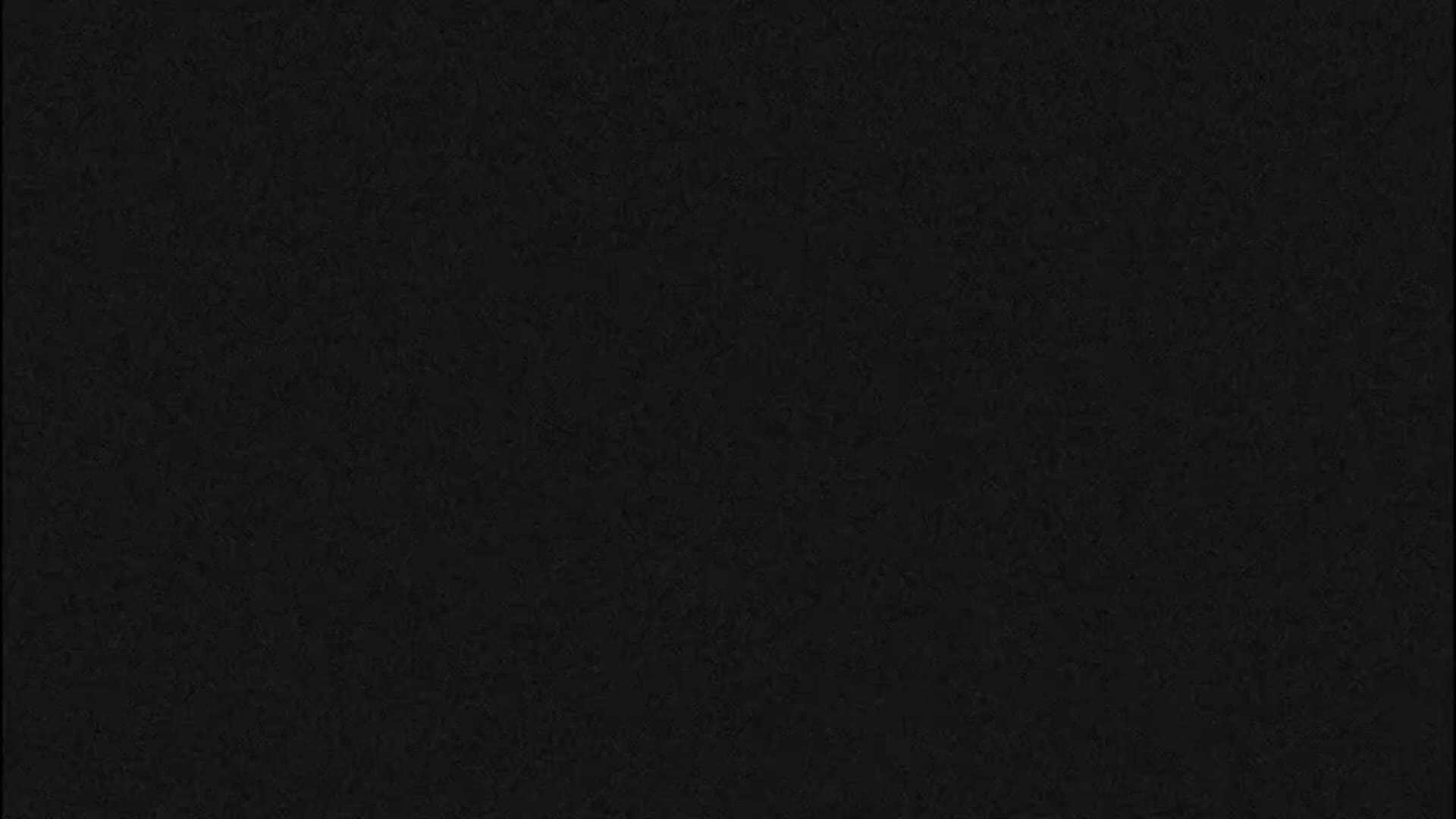 The image shows a solid dark-grey or black textured surface.