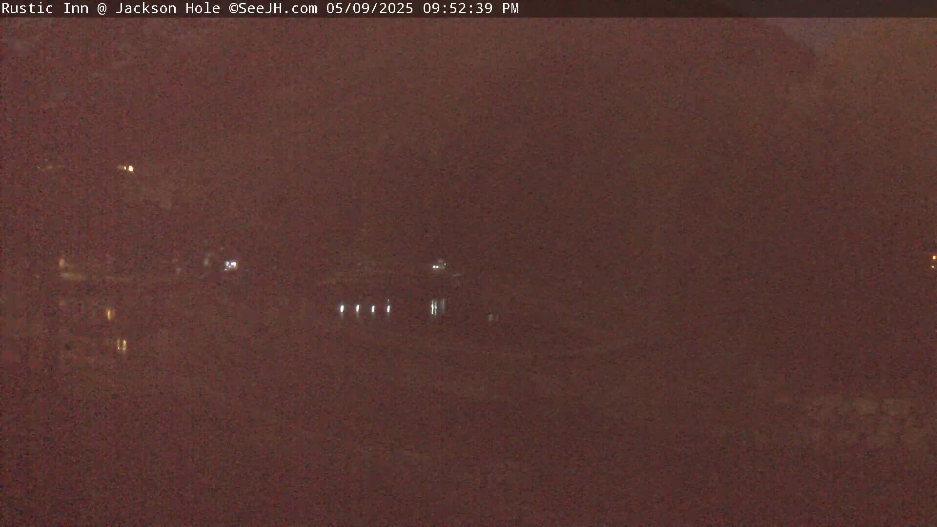 A nighttime long shot shows a dark, possibly snowy, landscape with a few distant lights.