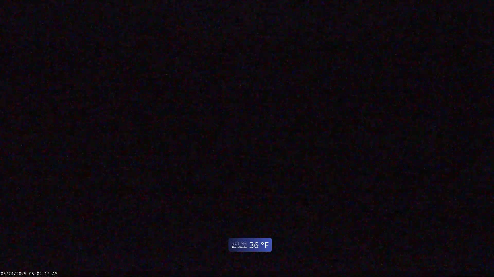 A completely dark image shows a nighttime outdoor scene with a temperature of 36°F.