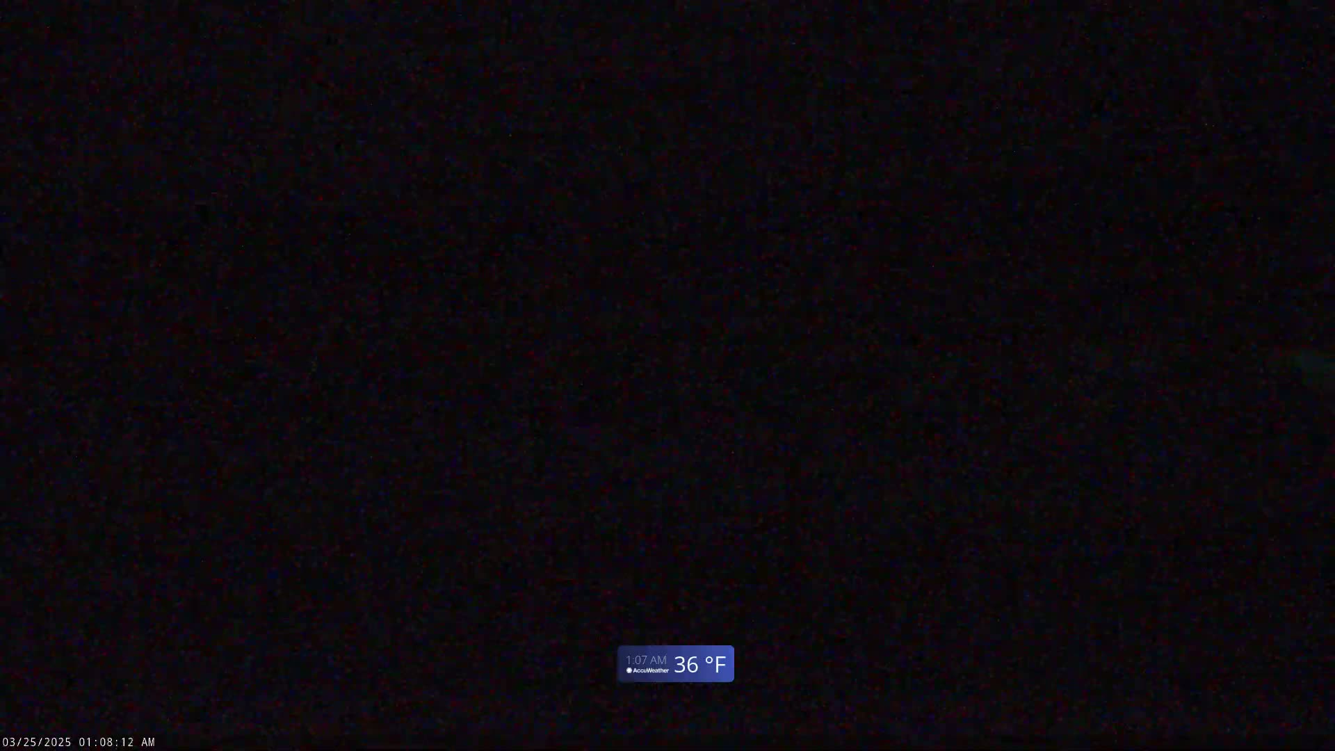 A completely dark image shows a nighttime outdoor scene with a temperature of 36 degrees Fahrenheit.