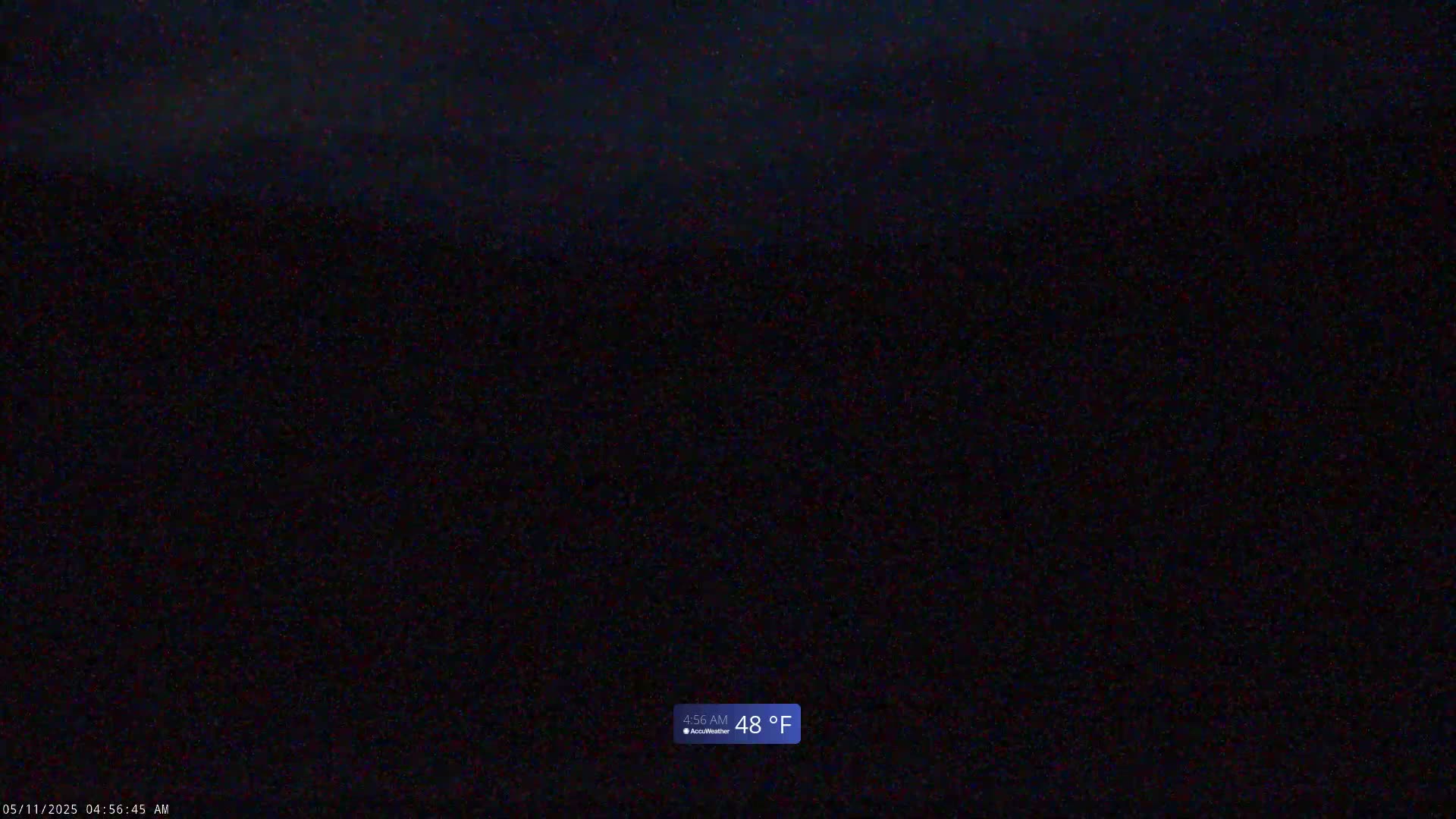 A dark, nighttime scene shows a mostly clear sky with a temperature of 48°F.