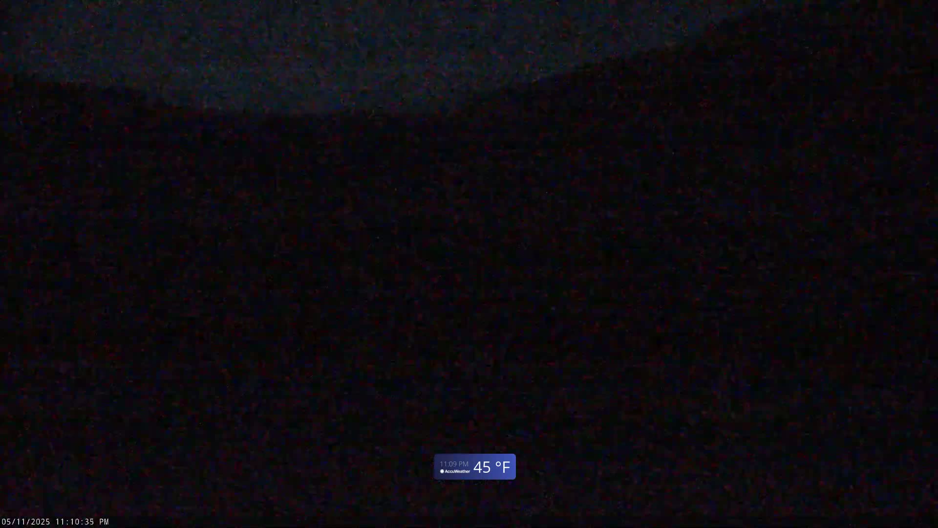 A nighttime outdoor scene shows dark hills under a dark sky, with the temperature at 45 degrees Fahrenheit.