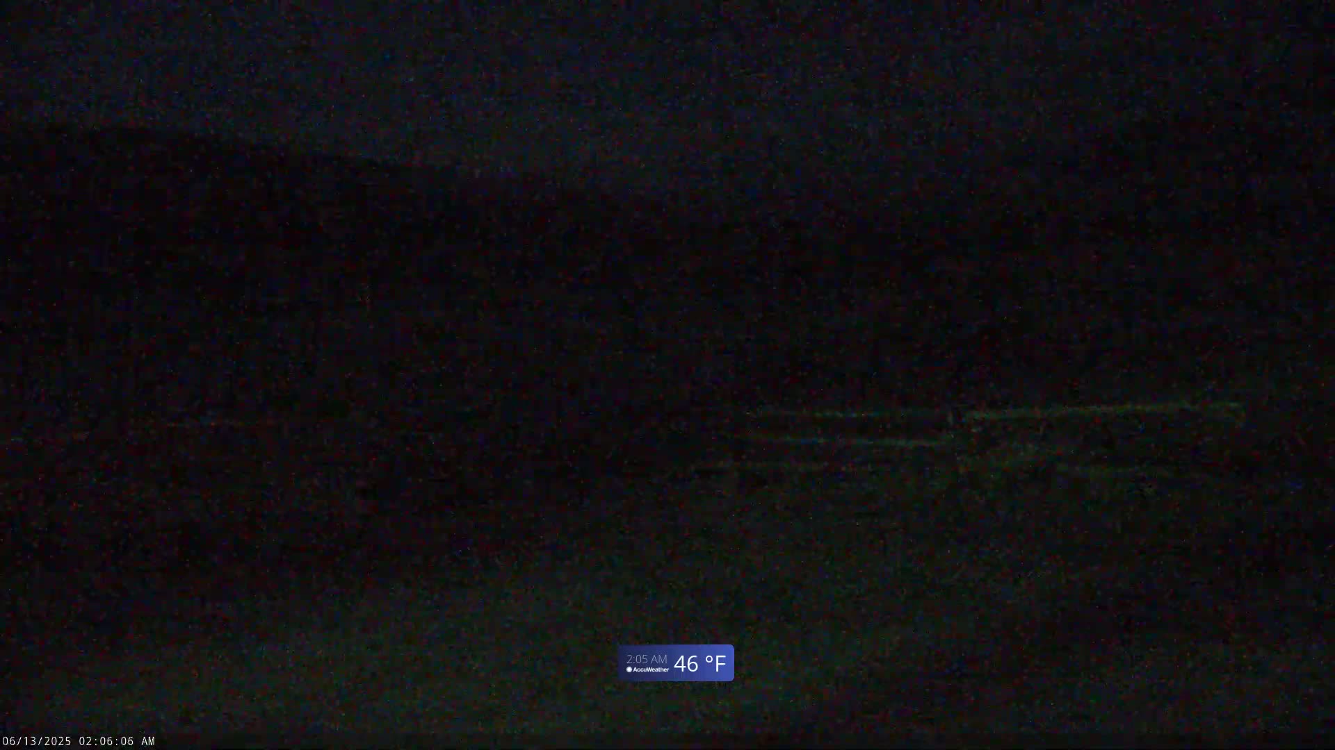 A dark, nighttime outdoor scene shows a blurry, indistinct landscape at 46°F.